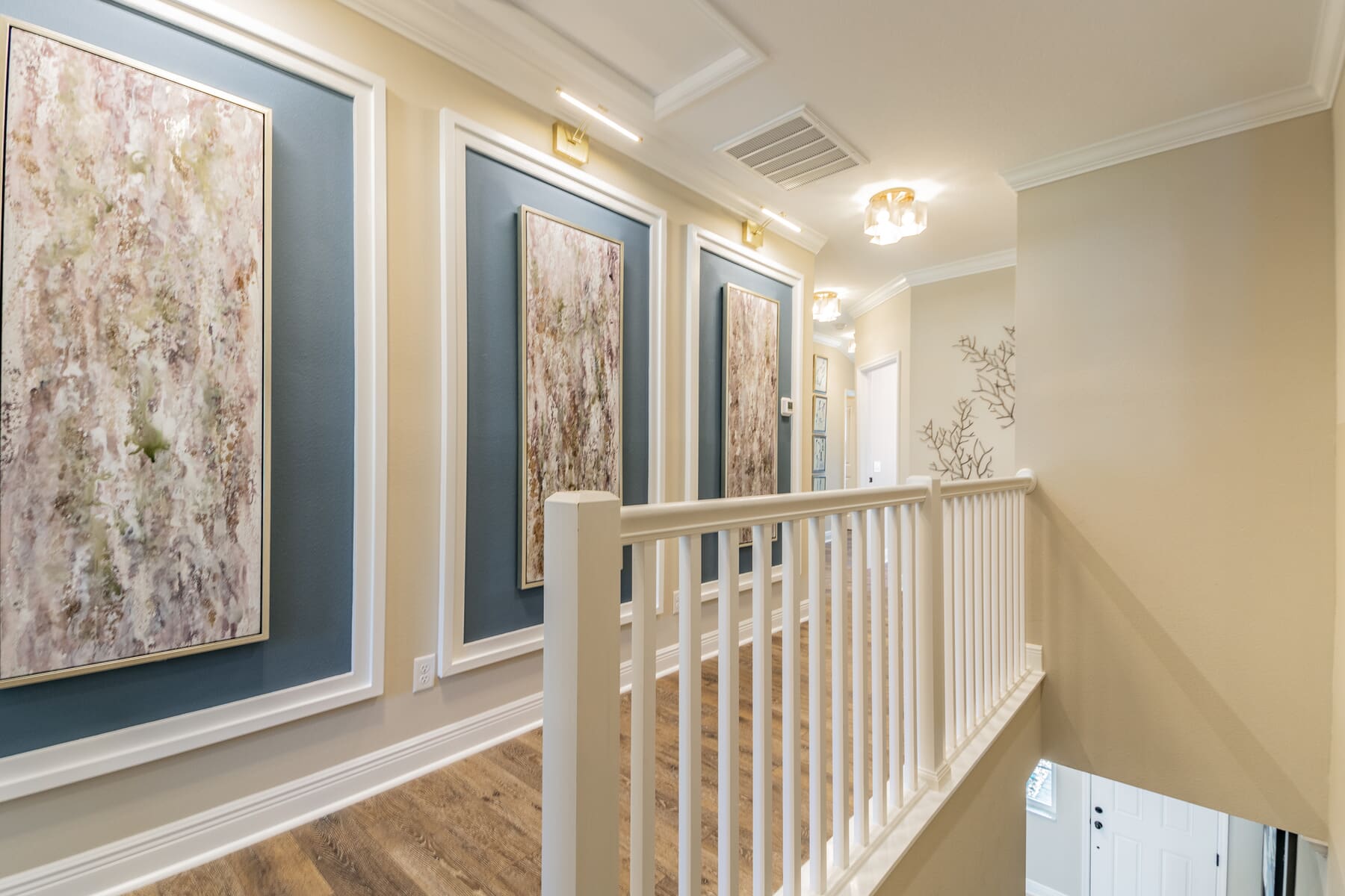 Hallway With Wall Art and Gold Display Lighting