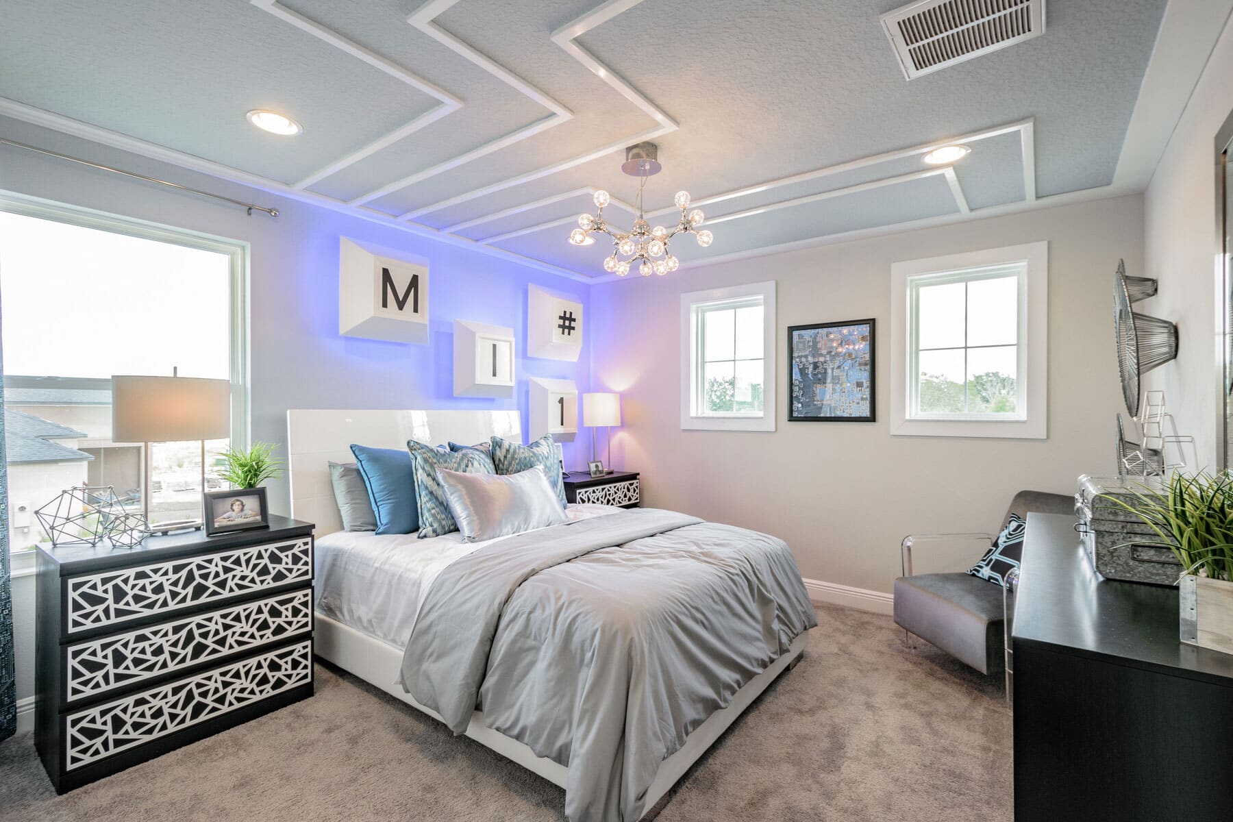 Bedroom With Metal Ceiling Light and Colored Wall Lights