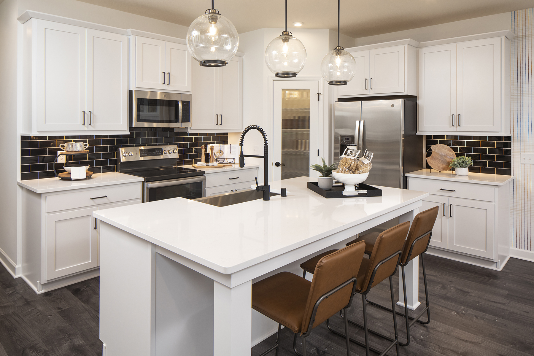 White Open-Concept Kitchen With Black Subway-Style Backsplash