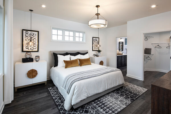 Photo of an owner's bedroom with a walk-in closet and an en-suite bathroom