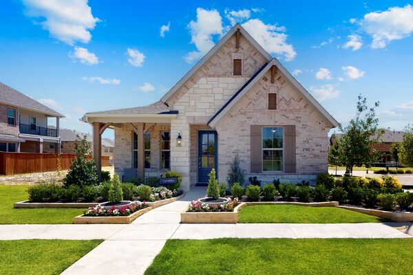 Exterior photo of a home with raised bed flower gardens