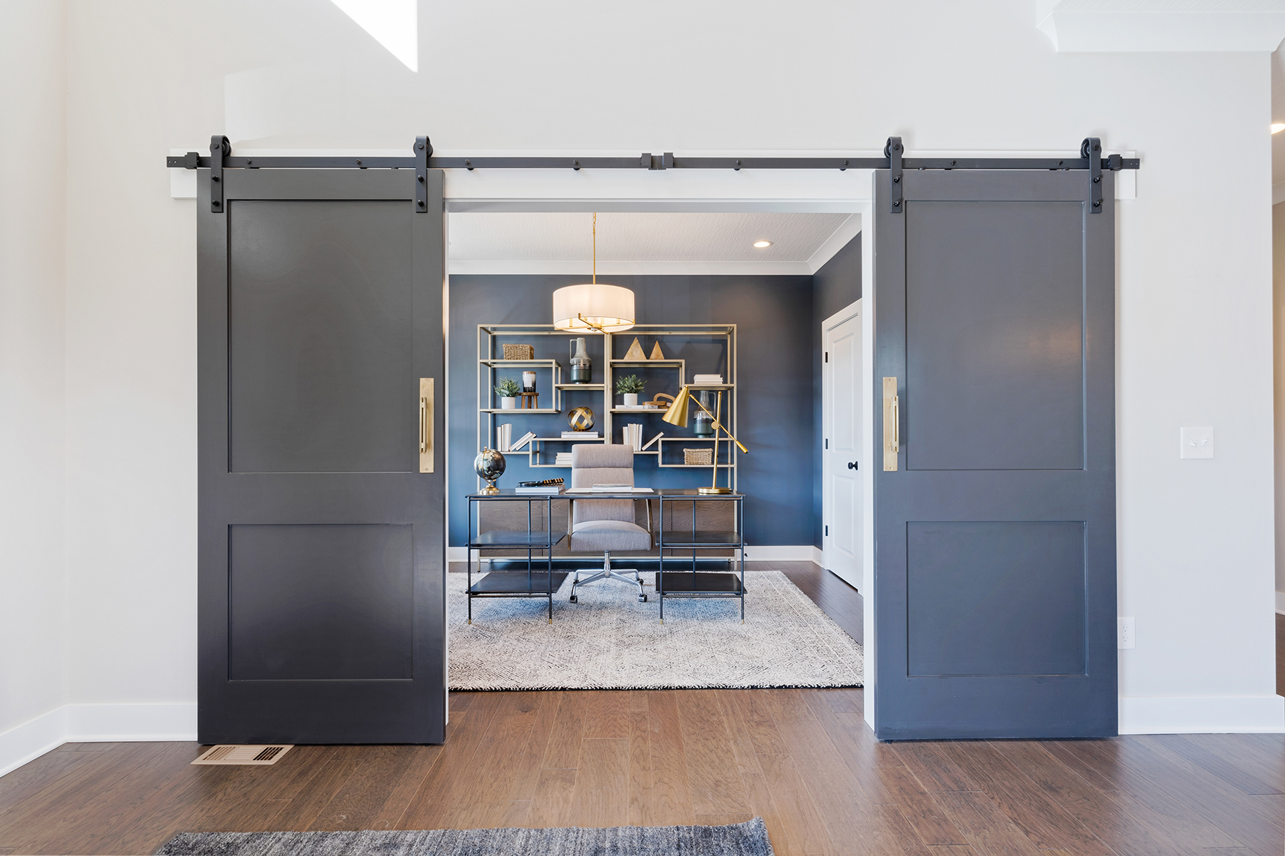 Office With Barn Door and Gold Decorative Accents