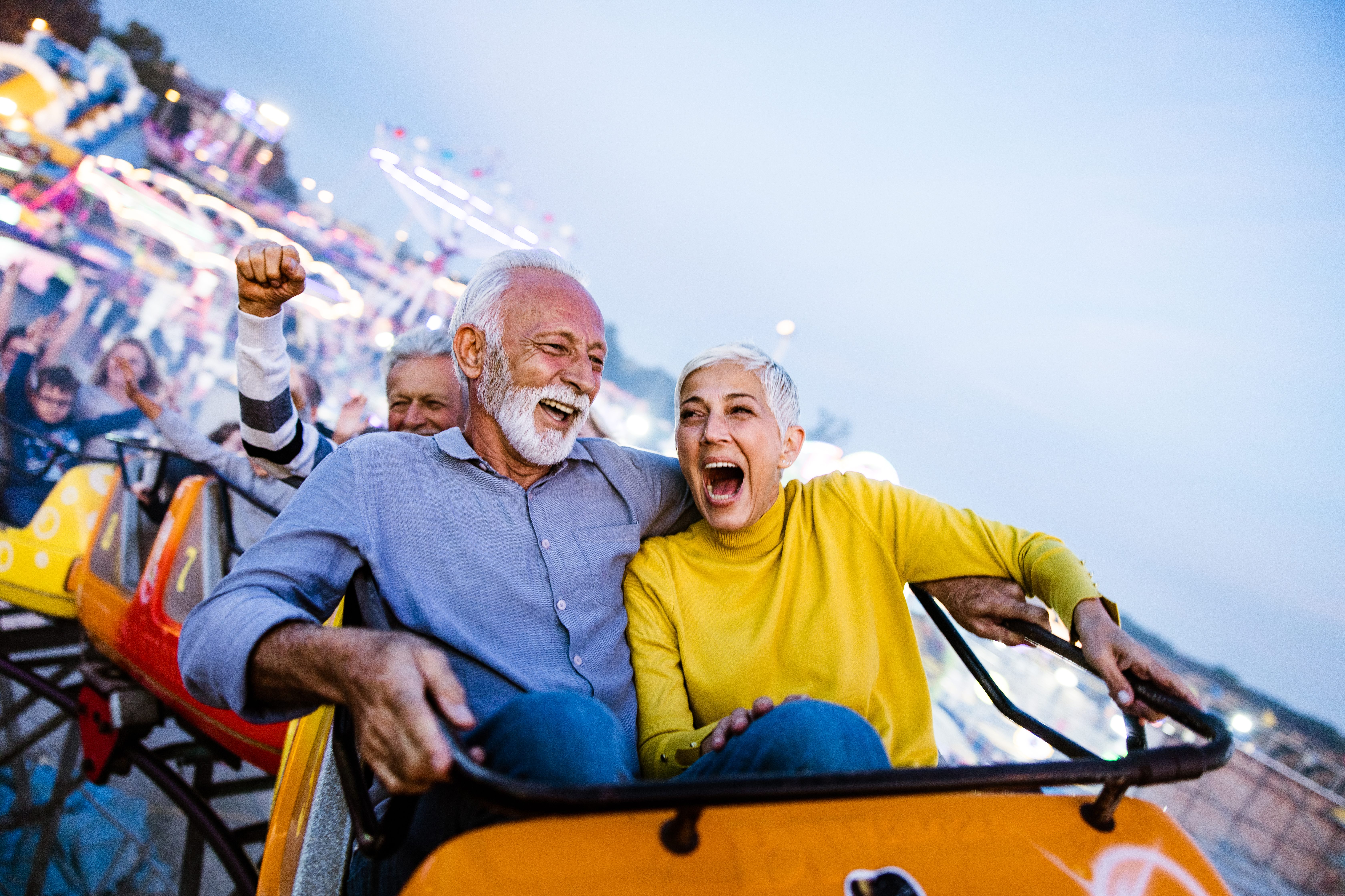Retired couple riding a rollercoaster