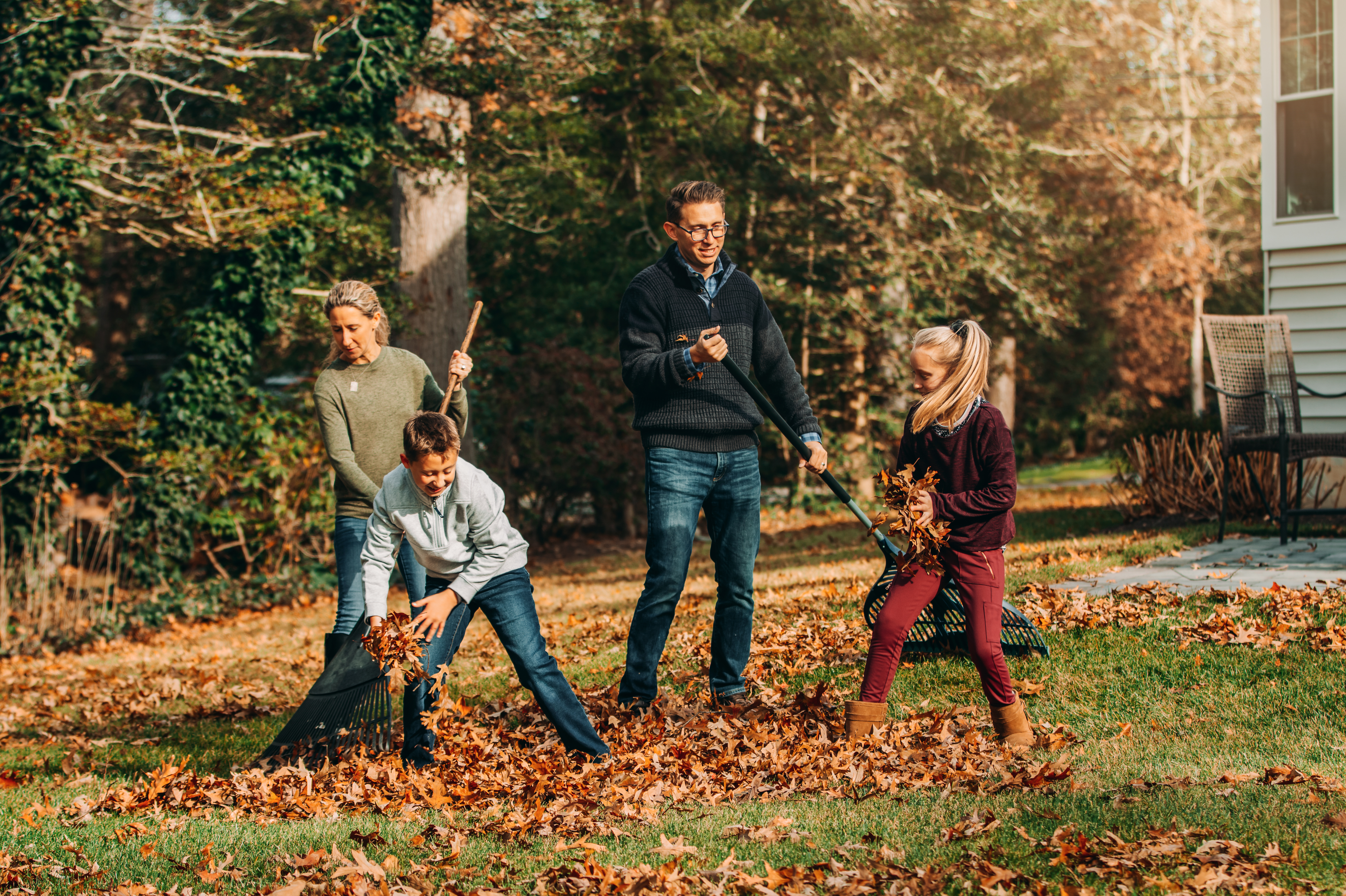 Family Raking Yard Together