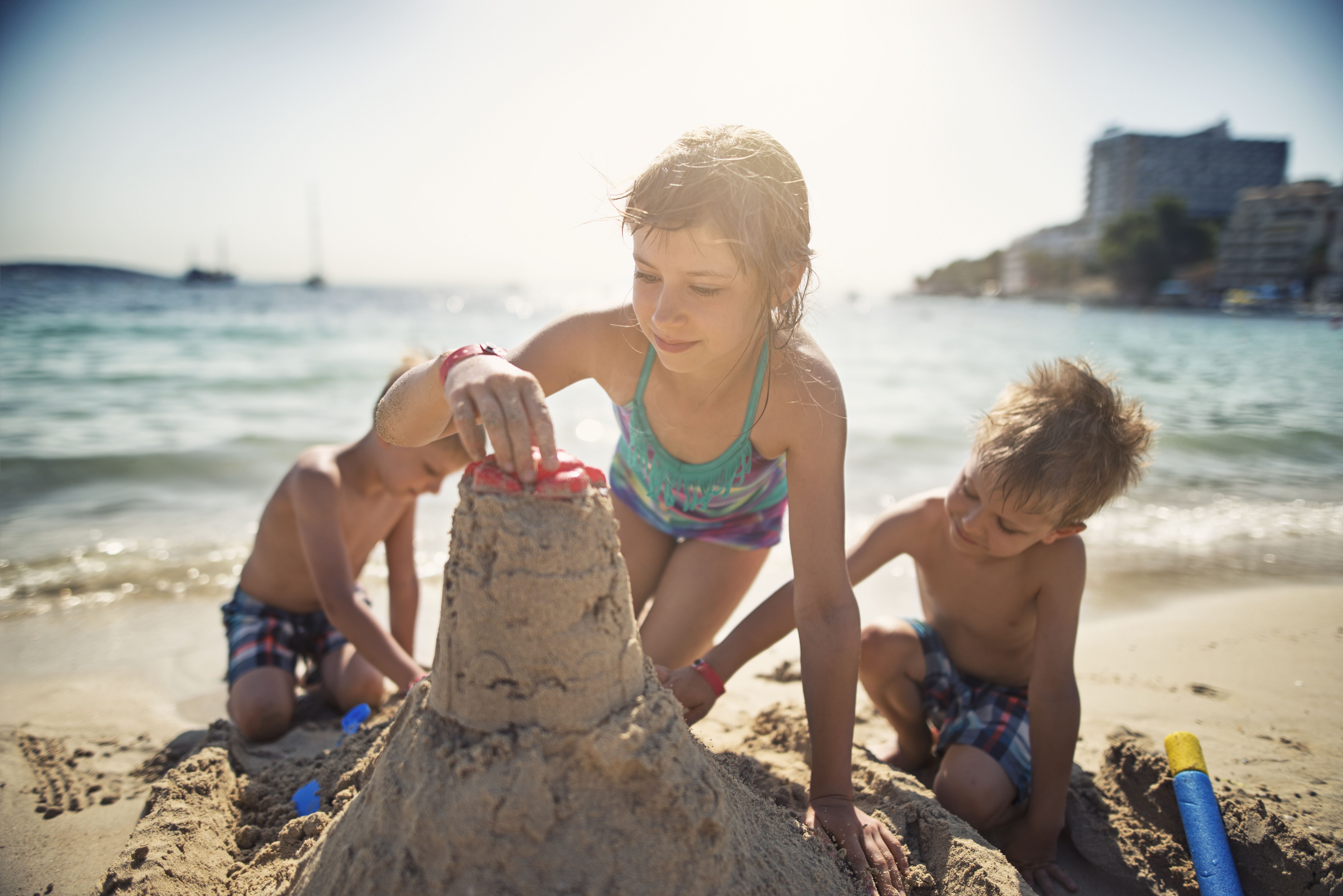 Kids Building Sand Castle on Beach