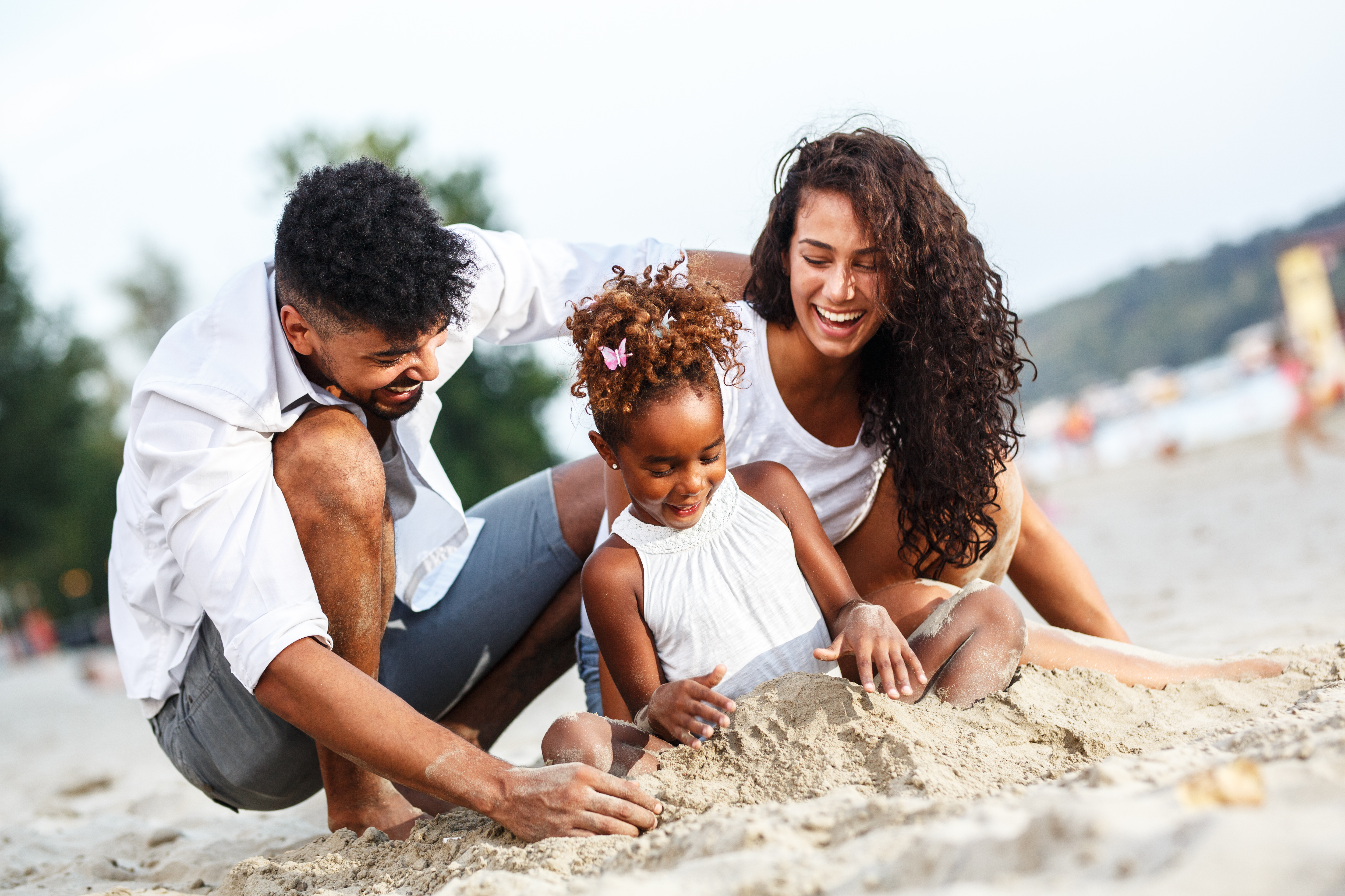 Family Playing in Sand on Beach