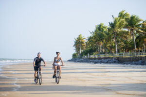 Couple biking along the beach
