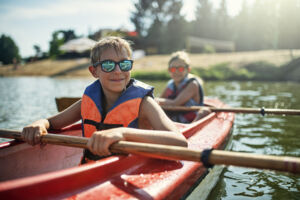 Kids rowing a canoe