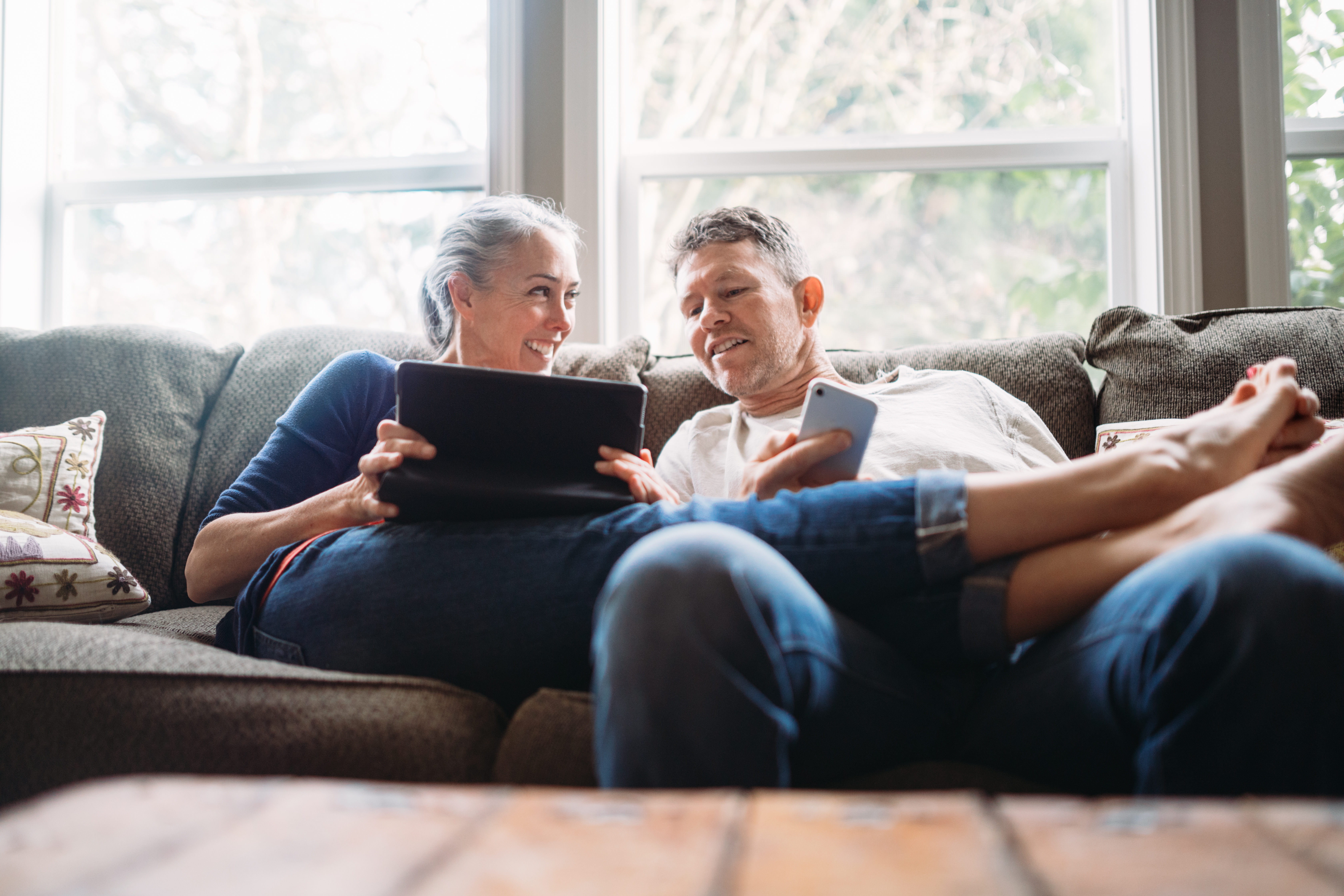 Senior Couple Planning on Couch With Tablet