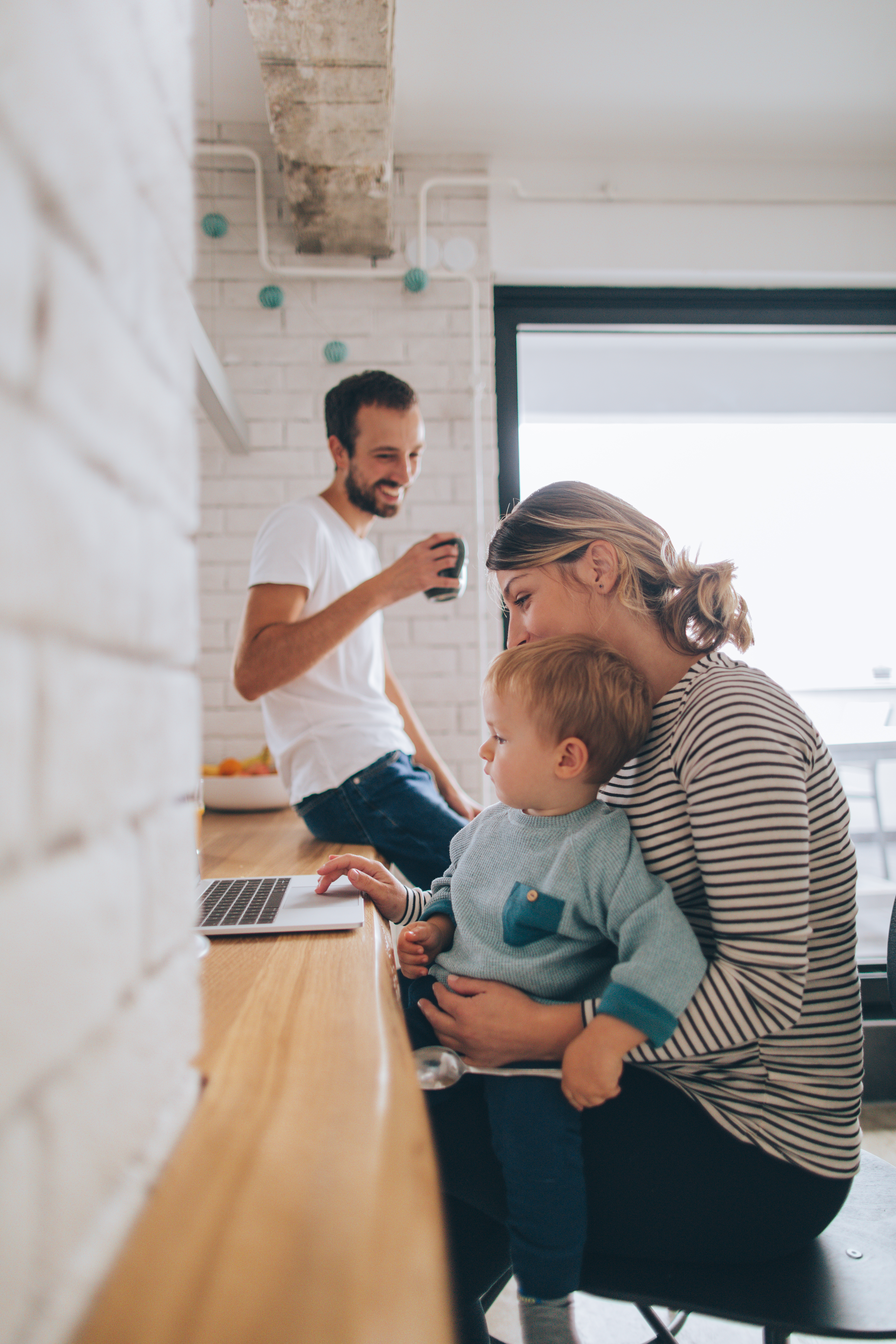 Mom Working on Laptop While Holding Baby