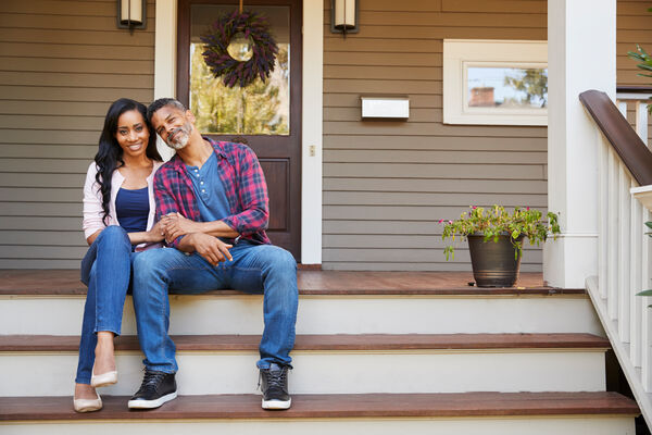 Homeowners on Front Steps of Home