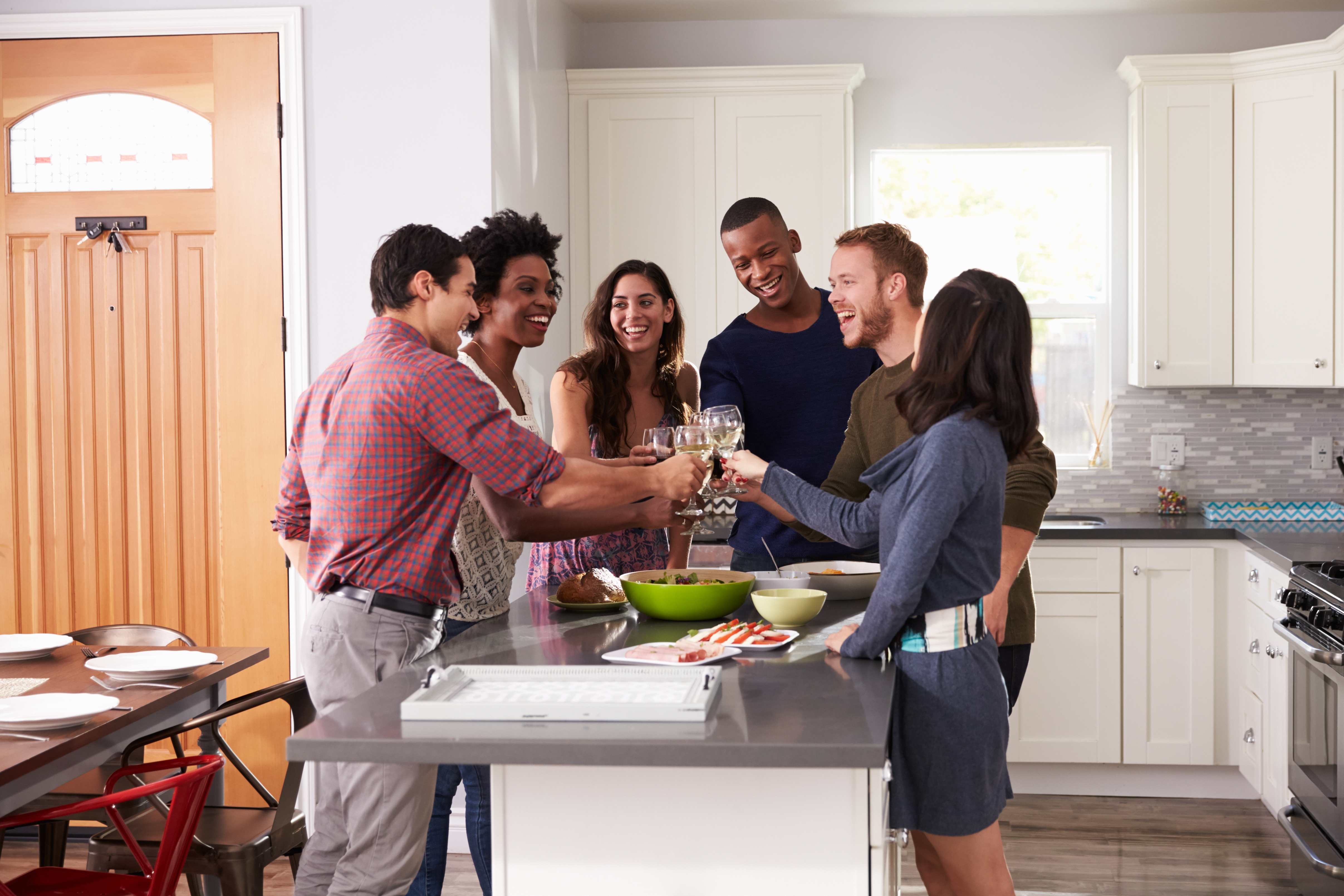 People Toasting at Kitchen Island