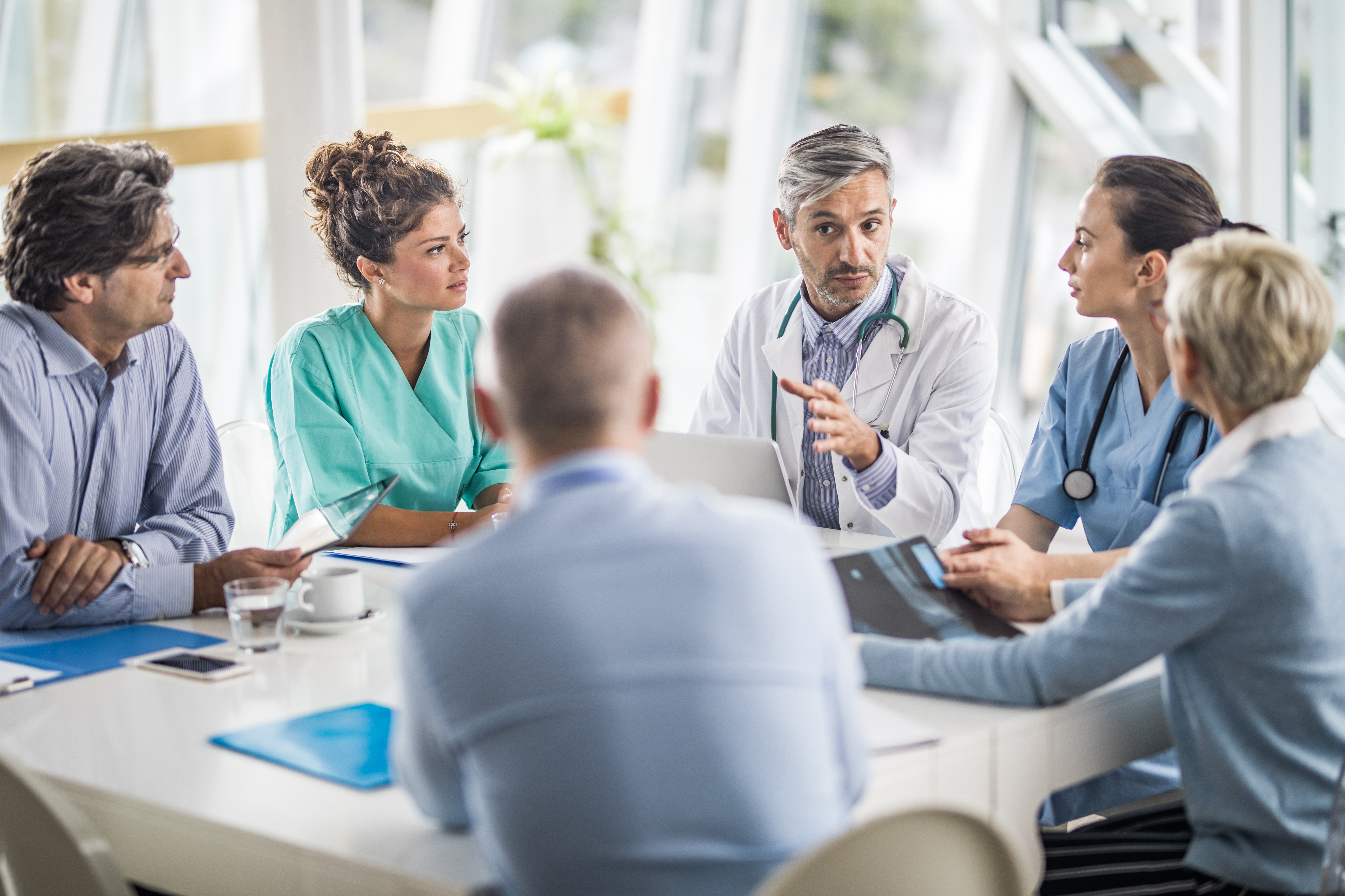 Group of doctors and nurses talking in a meeting