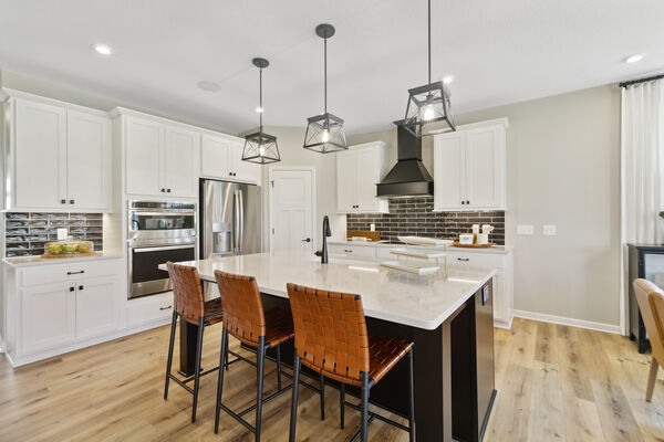 Photo of a kitchen with a large central island with seating