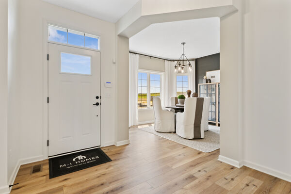 Photo of a den entry with winged walls in a new construction home
