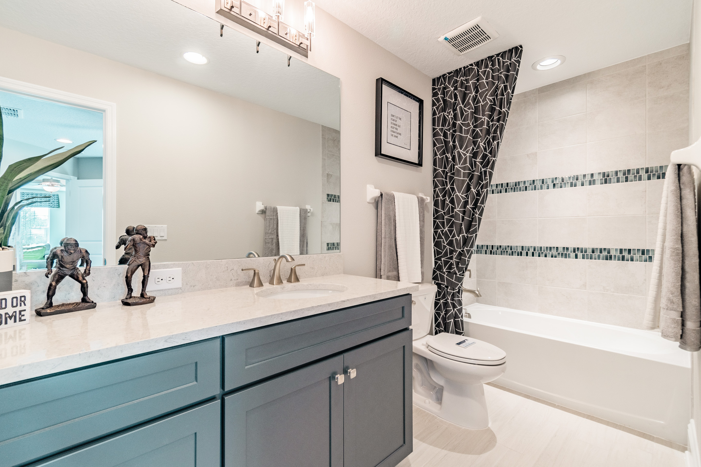 Bathroom With Vanity Lights and Recessed Lighting Above Shower