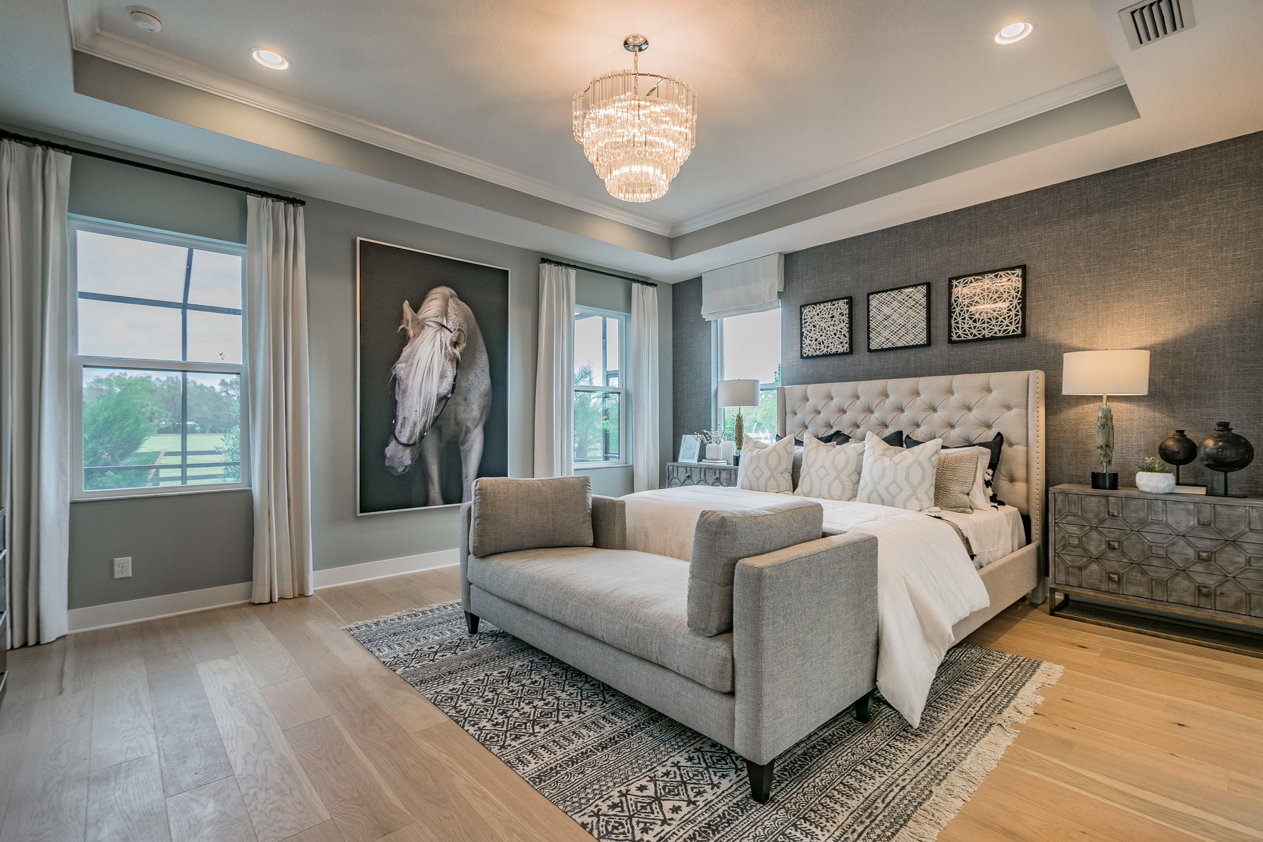 Owner's Bedroom With Large Wall Art and Chandelier