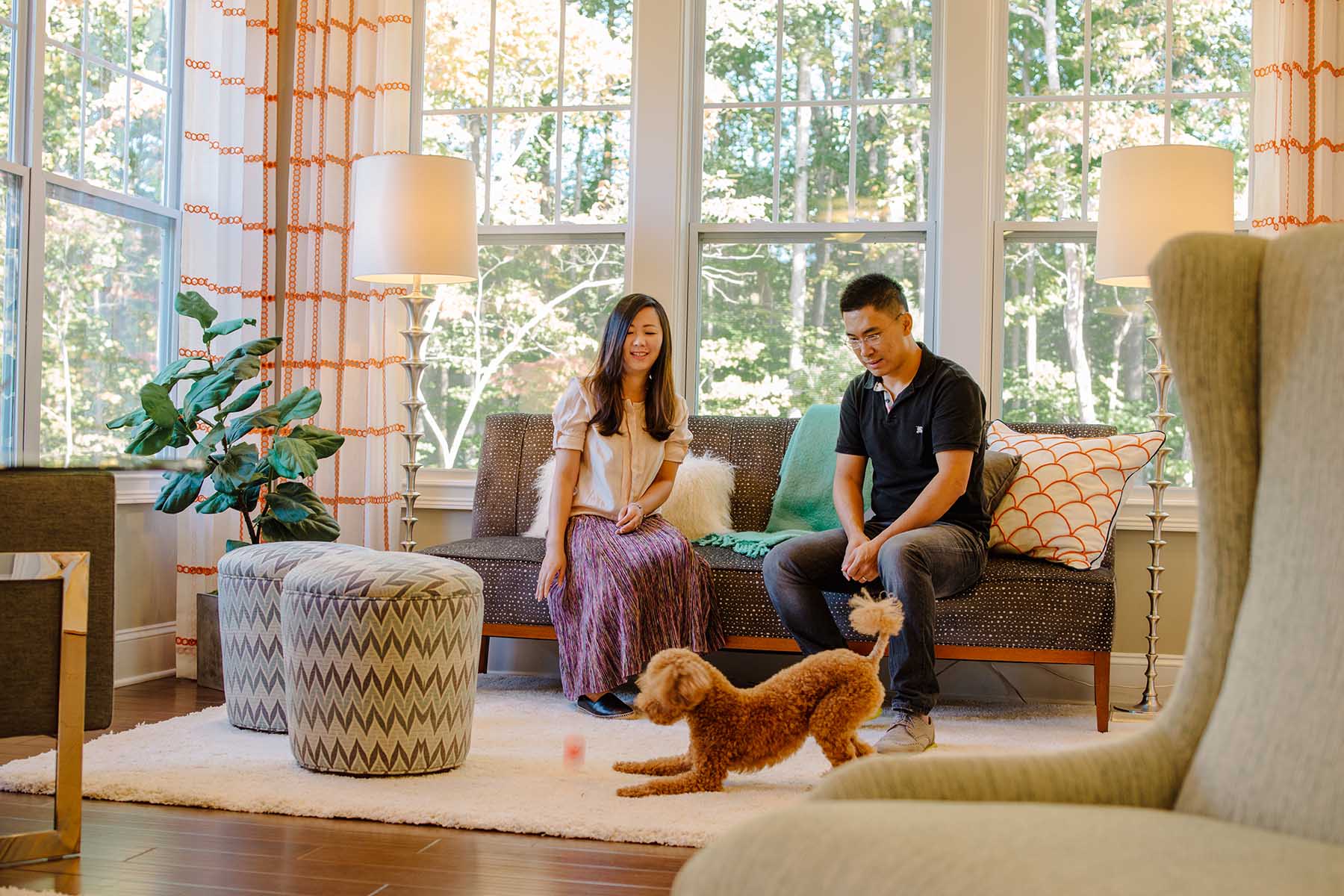 Couple Playing With Dog in Living Room