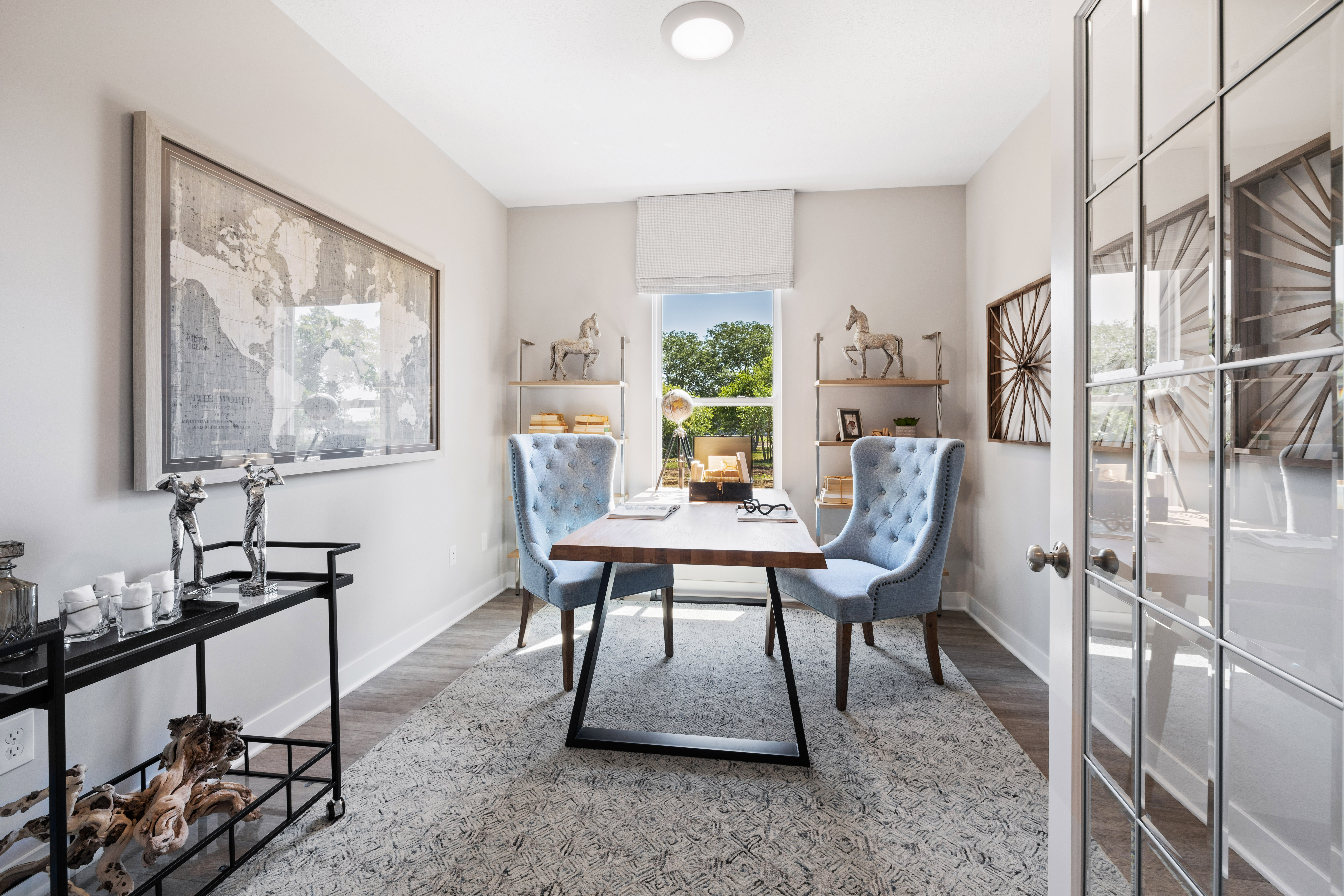 Modern White Home Office With Desk and Blue Accent Chairs