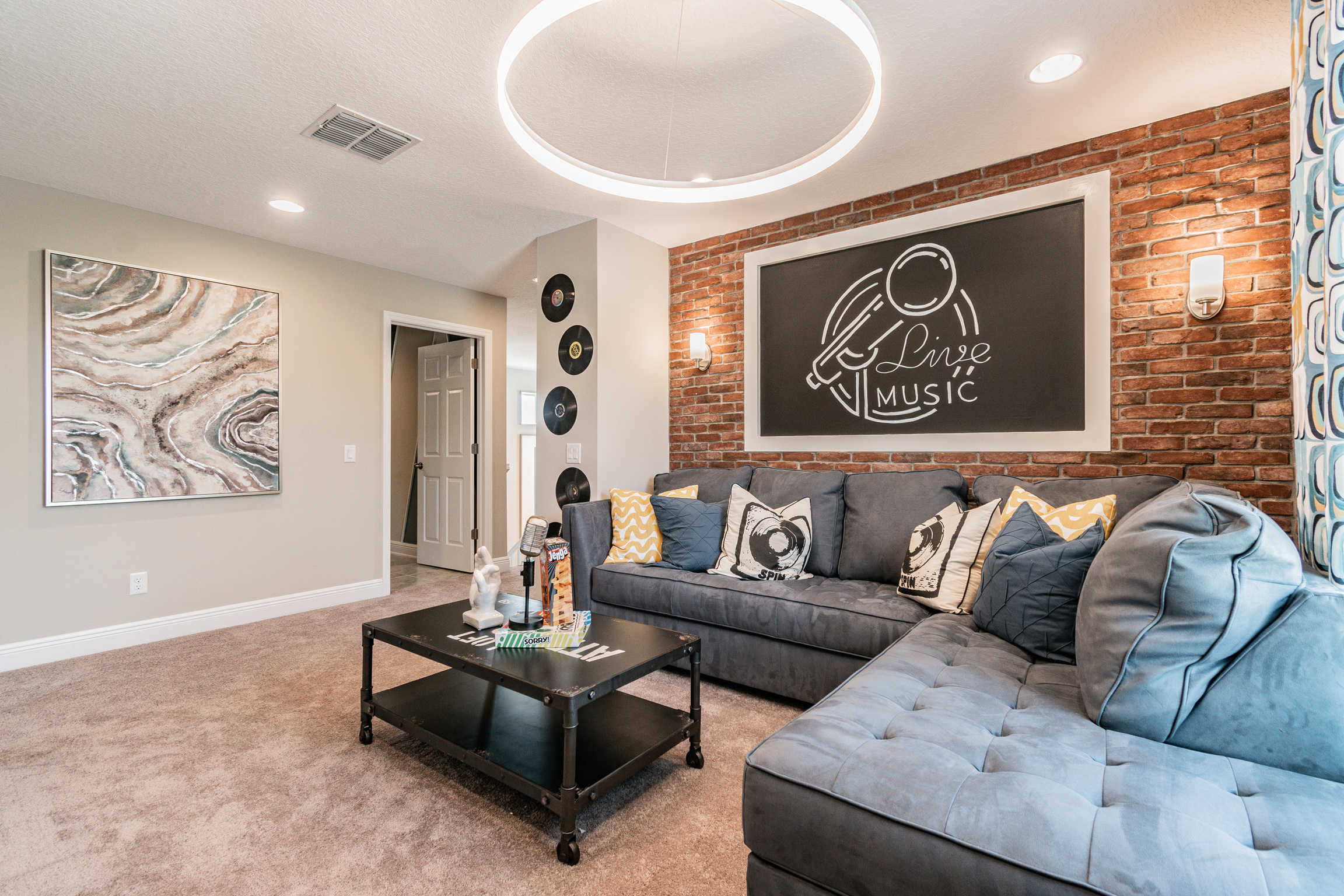 Living Room With Bright Circle Ceiling Light and Wall Sconces