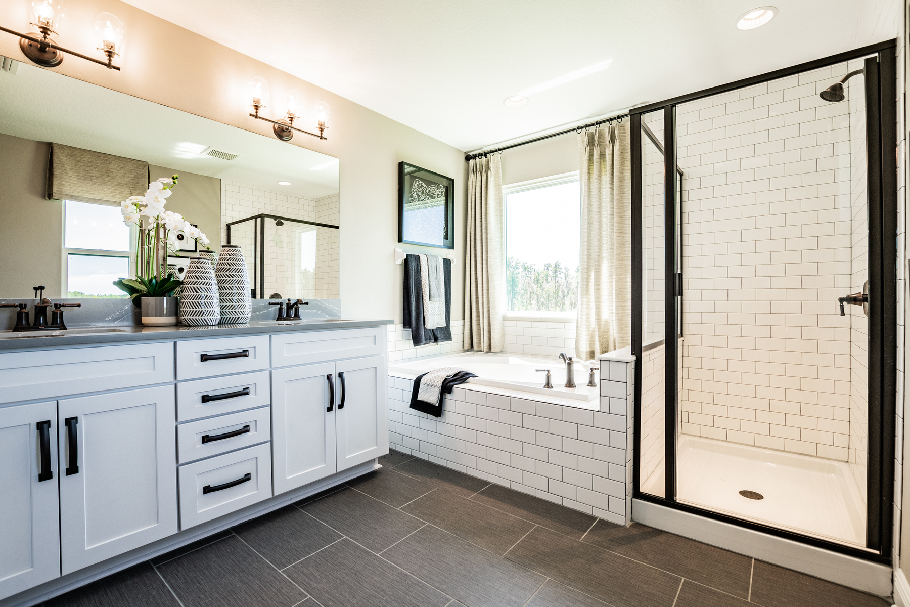 Owner's Bathroom With Subway Tile and Dual Vanities