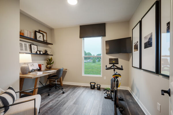 Image of an office with a desk and workout equipment