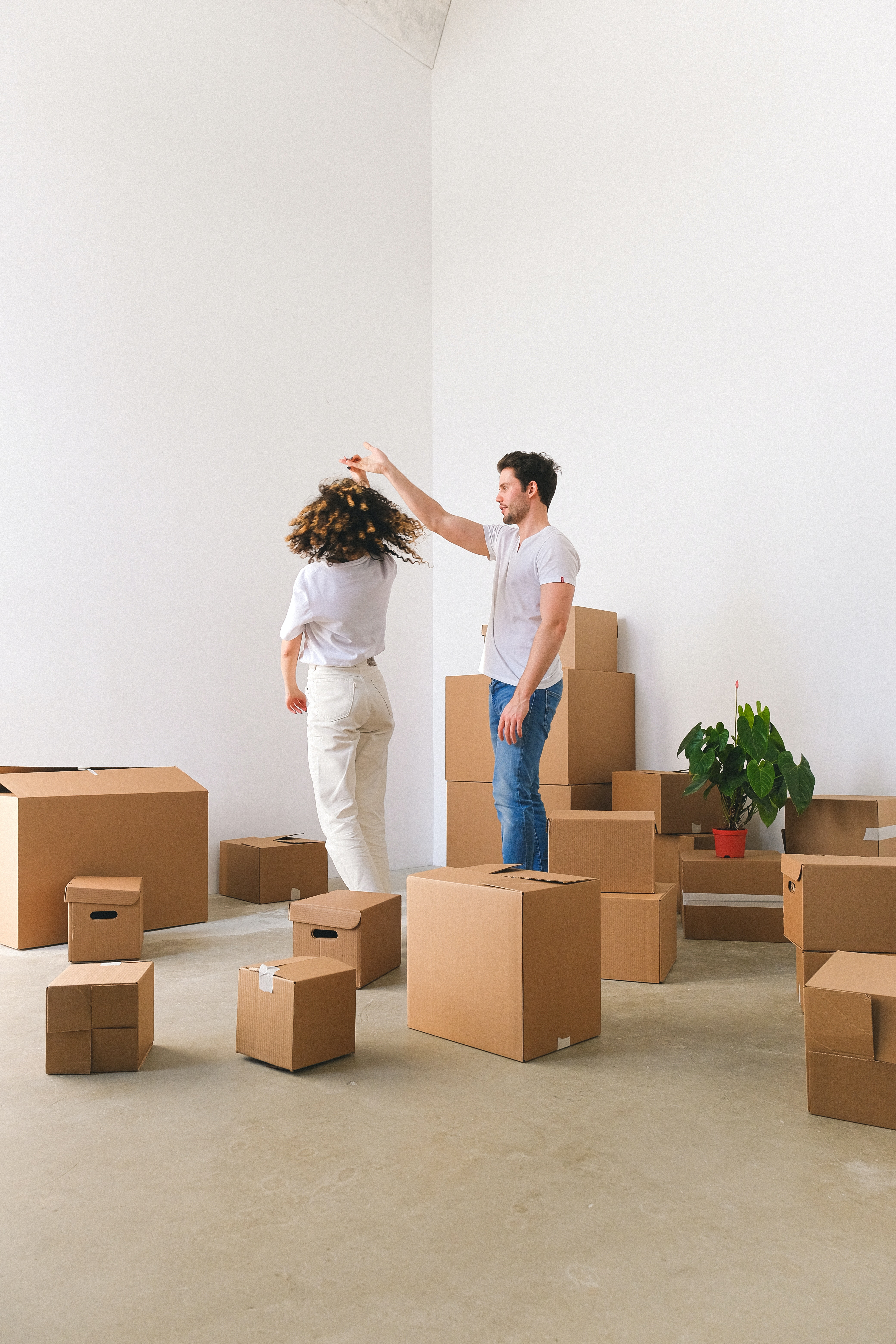 Homeowners Dancing by Moving Boxes