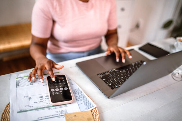 Closeup of woman calculating expenses