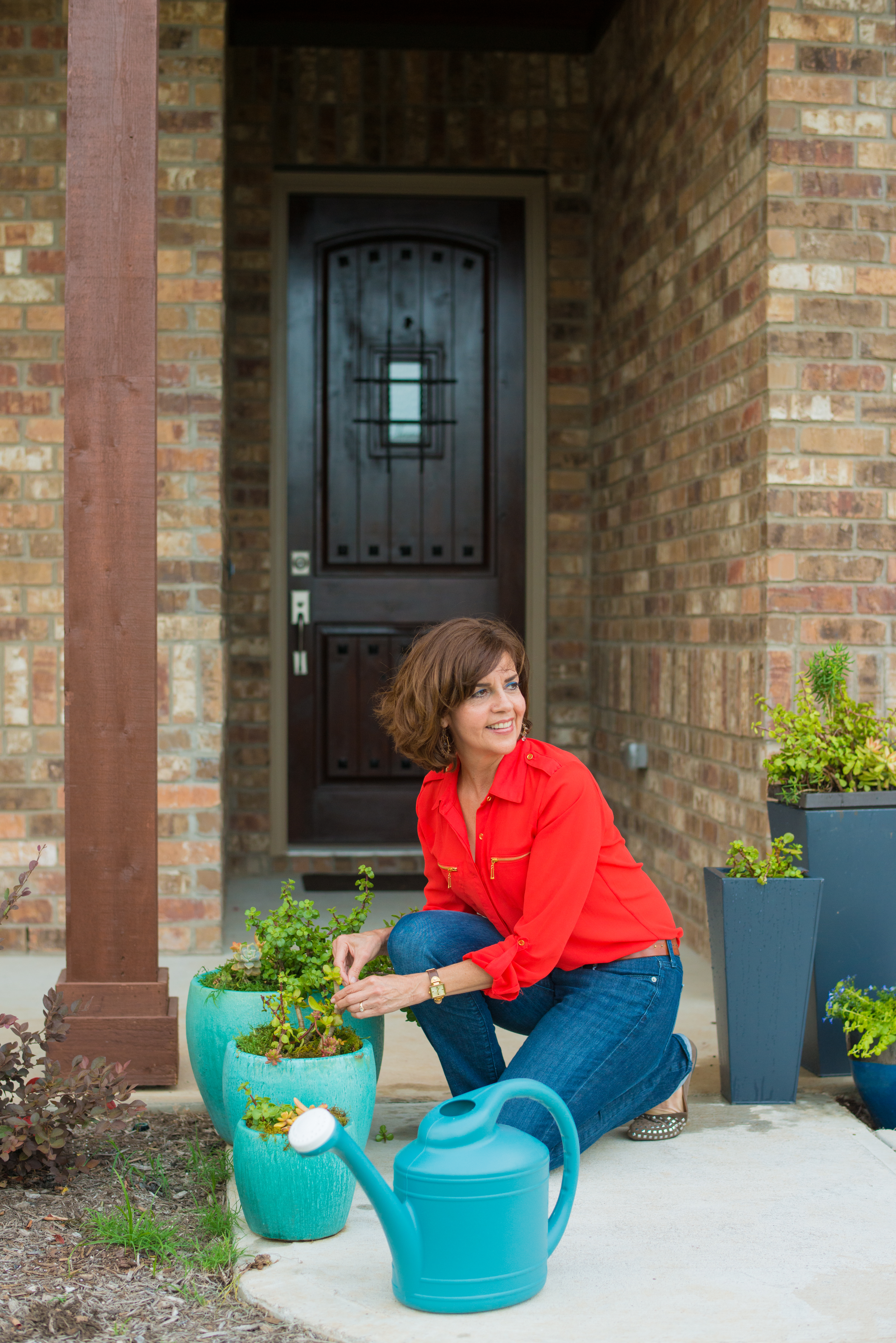 Woman Watering Plants With Watering Can