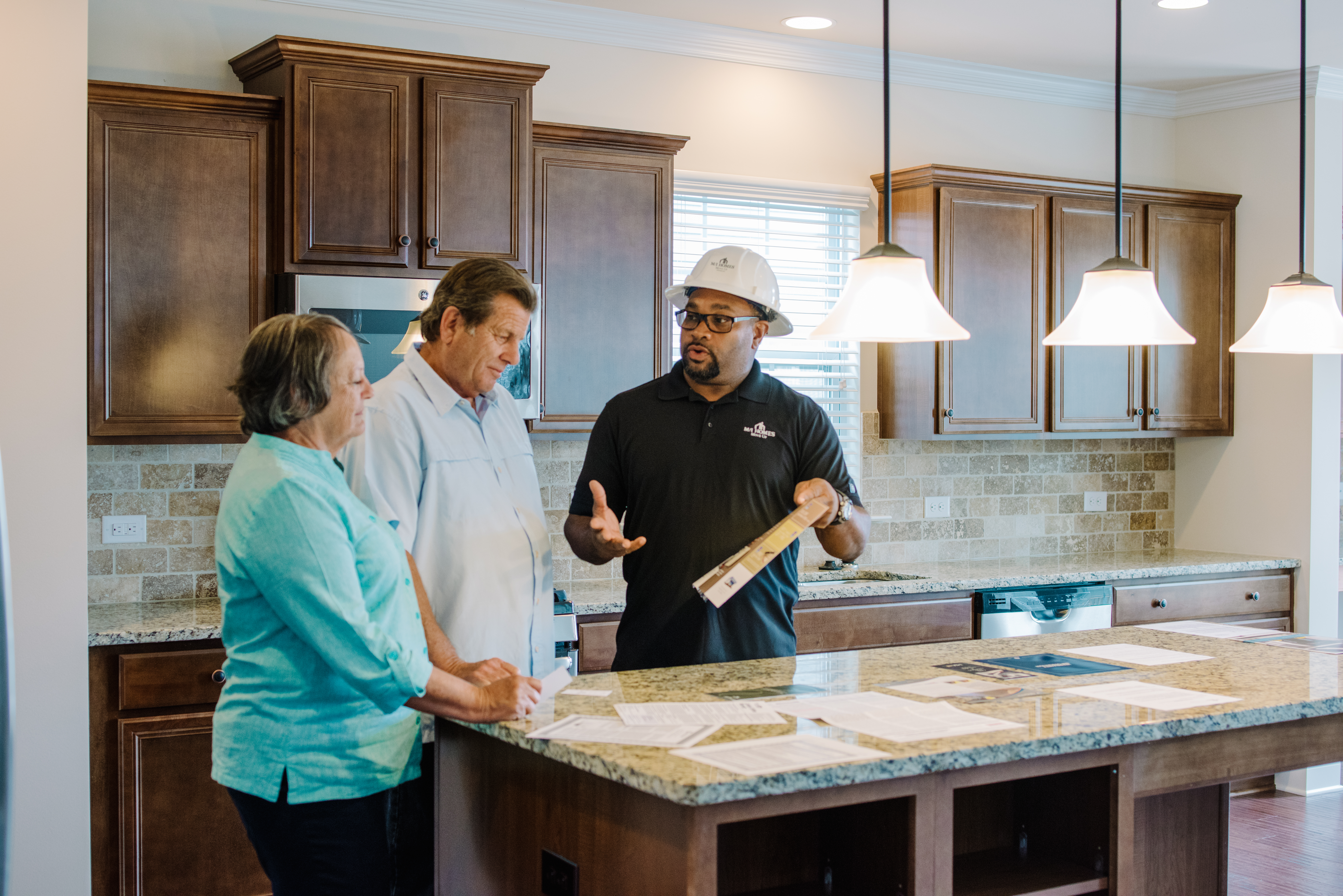 Construction Manager With Homebuyers in New Home