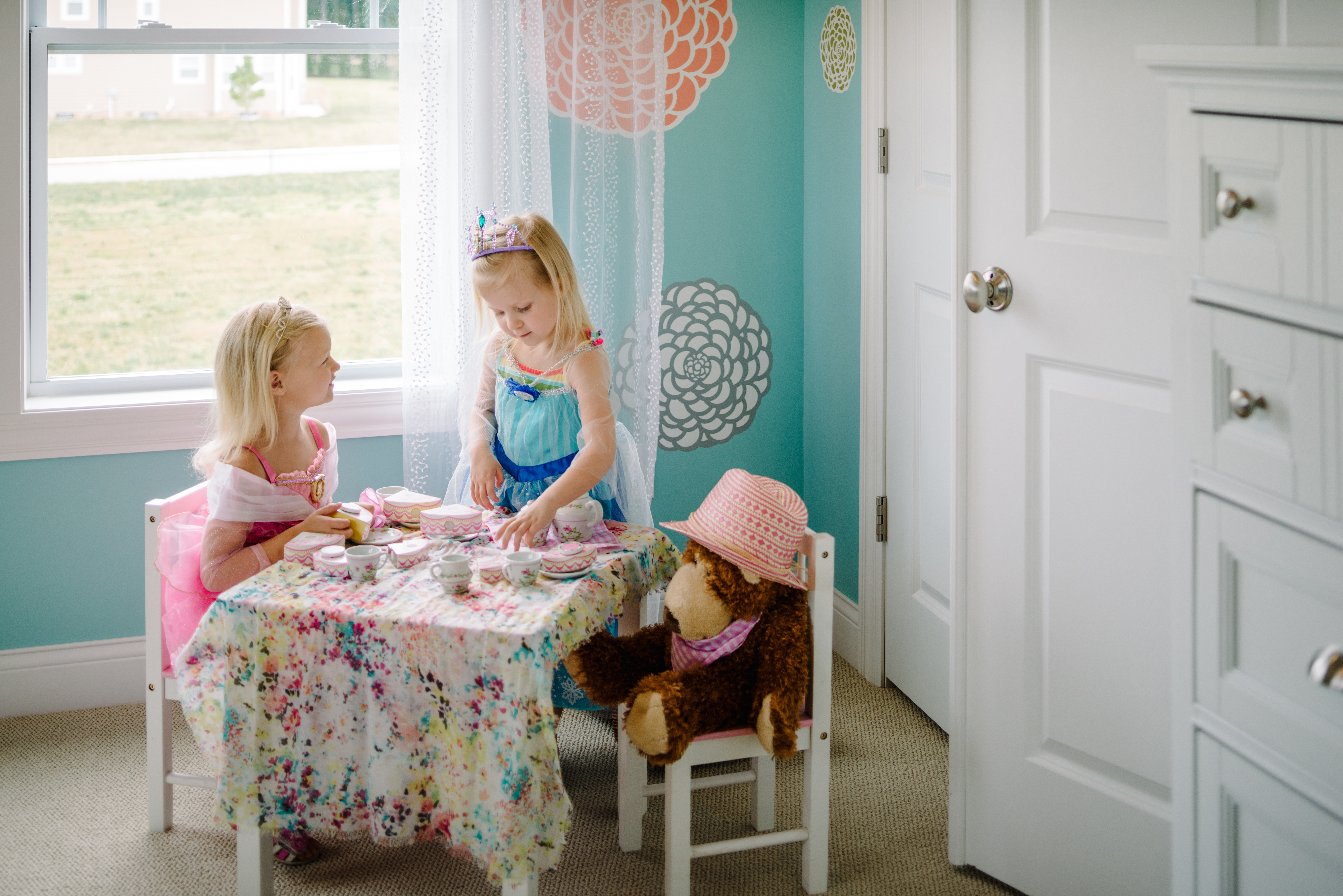 Girls Playing Dress Up With Tea Party in Play Room