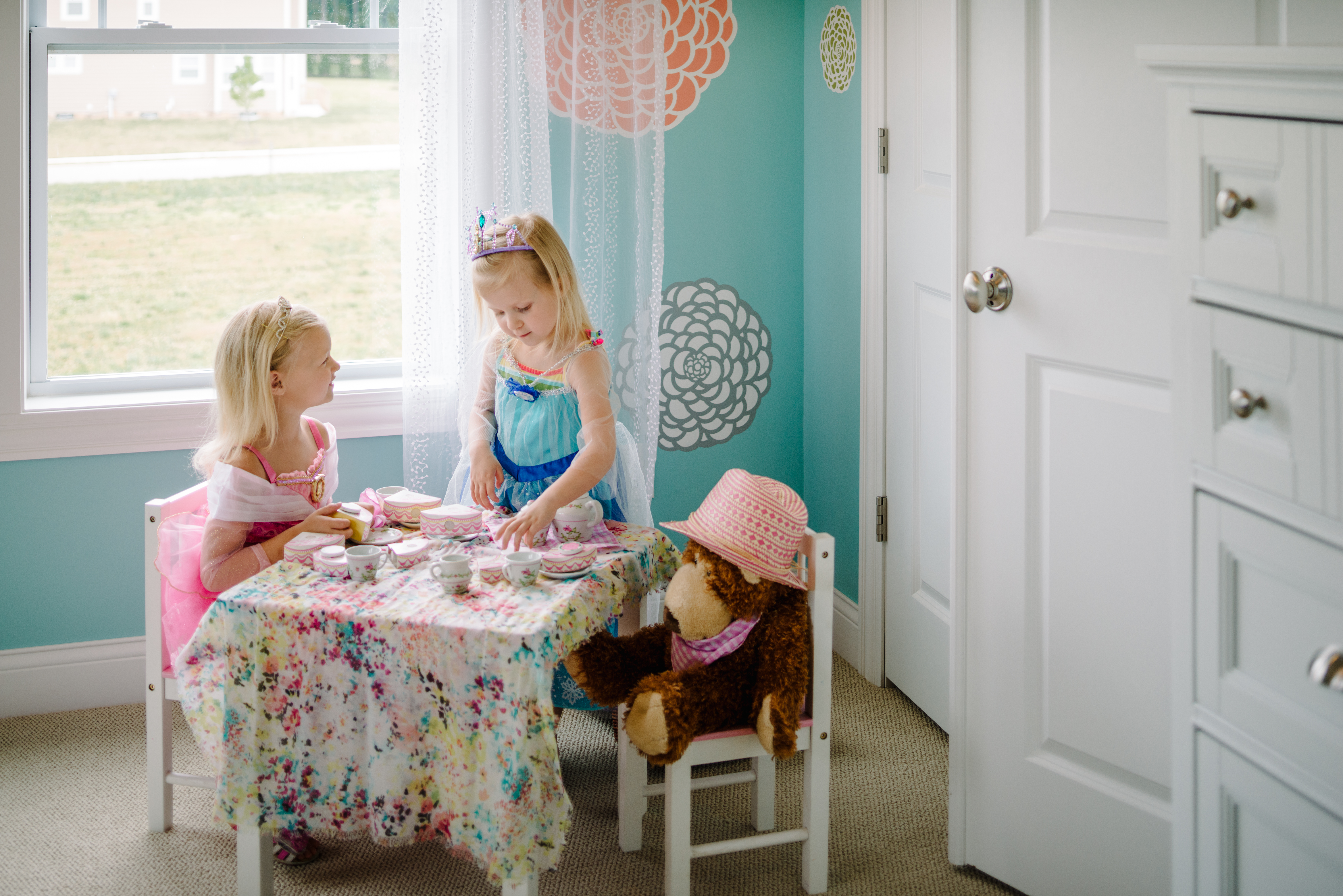 Girls Playing Dress Up With Tea Party in Play Room