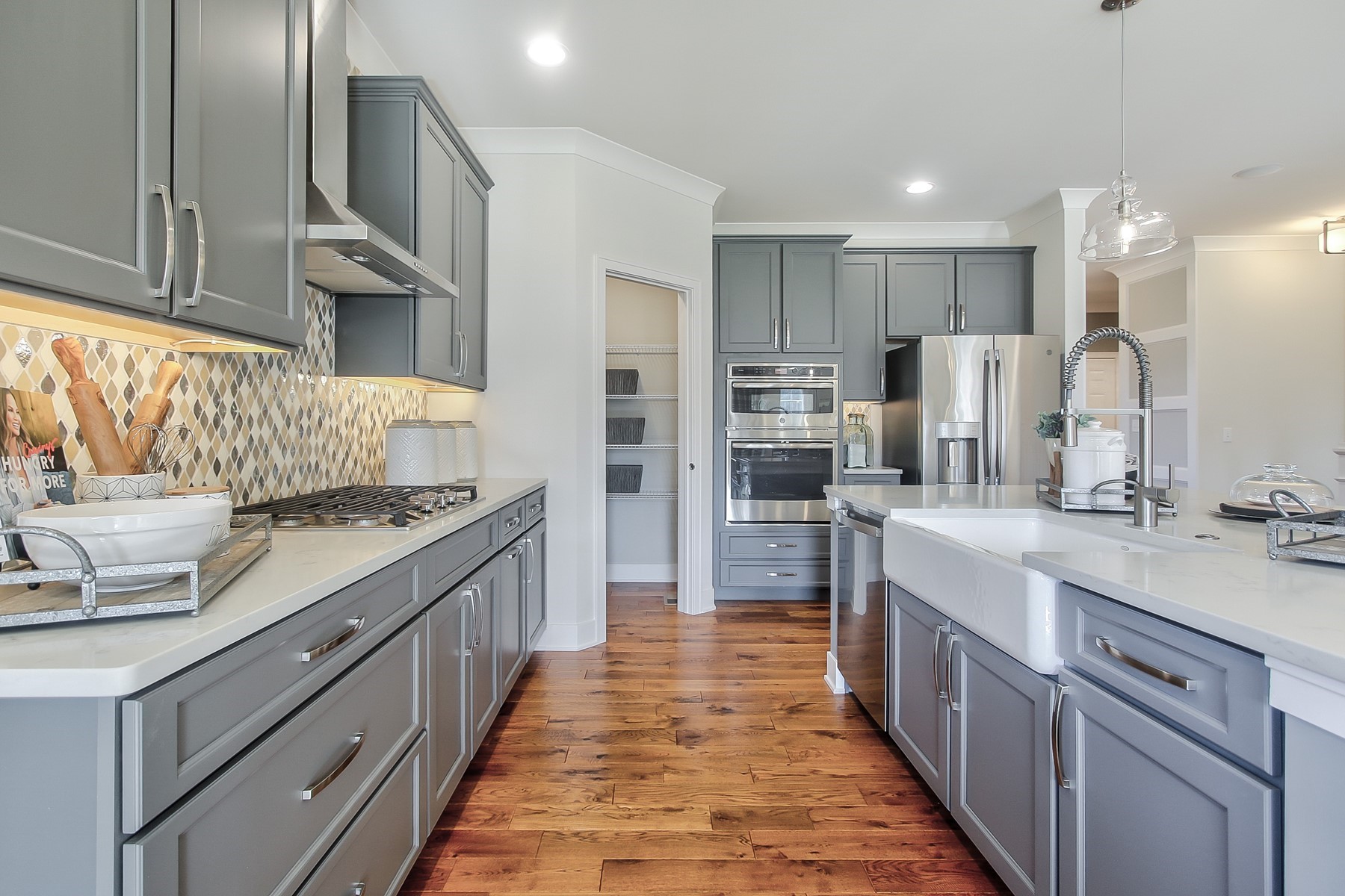 Kitchen With Gray Cabinets and a Double-Wall Oven