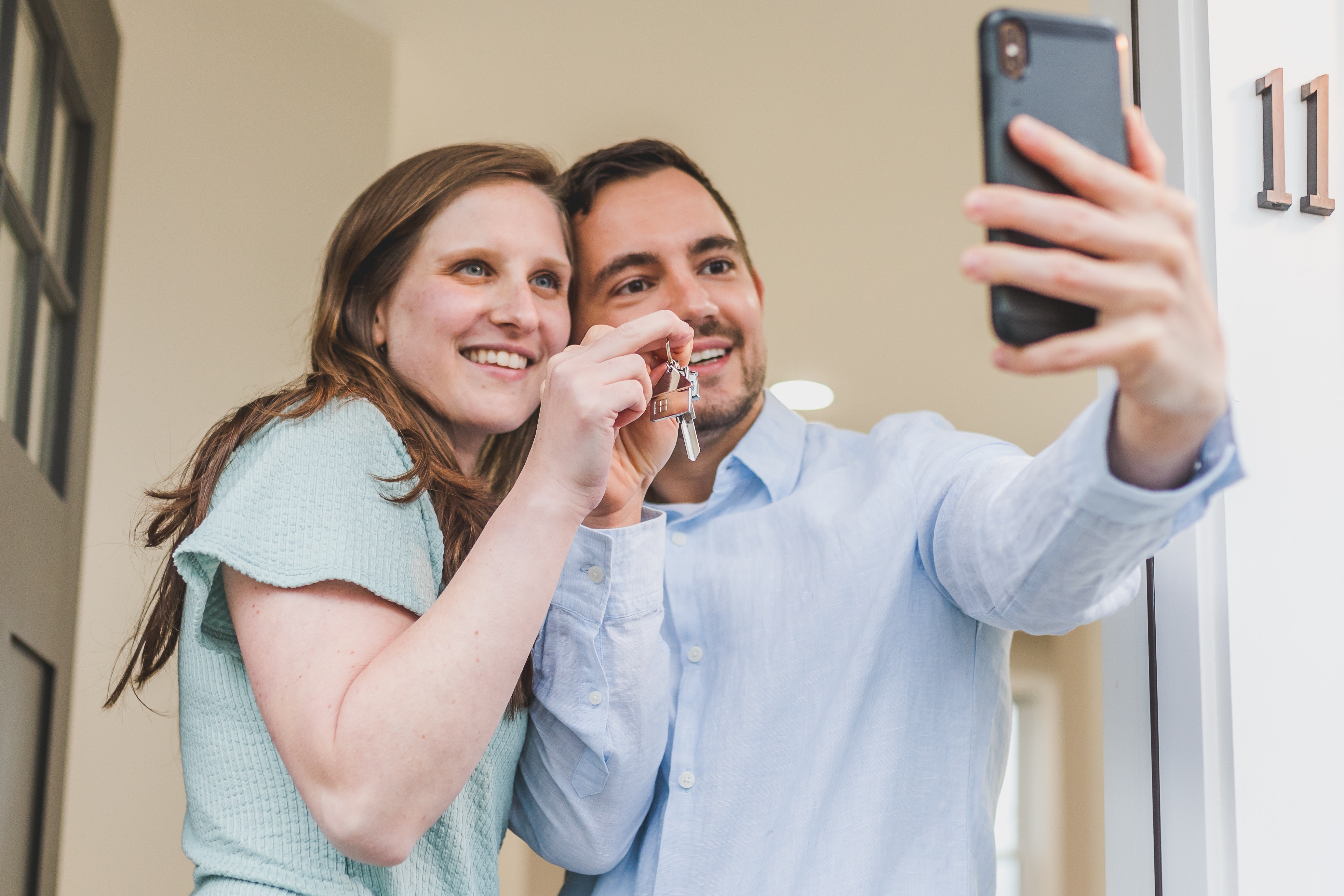 New Homeowners Taking Selfie With Keys
