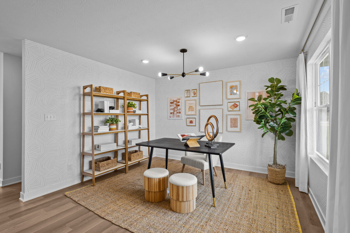 Home office with warm tones and a gallery wall