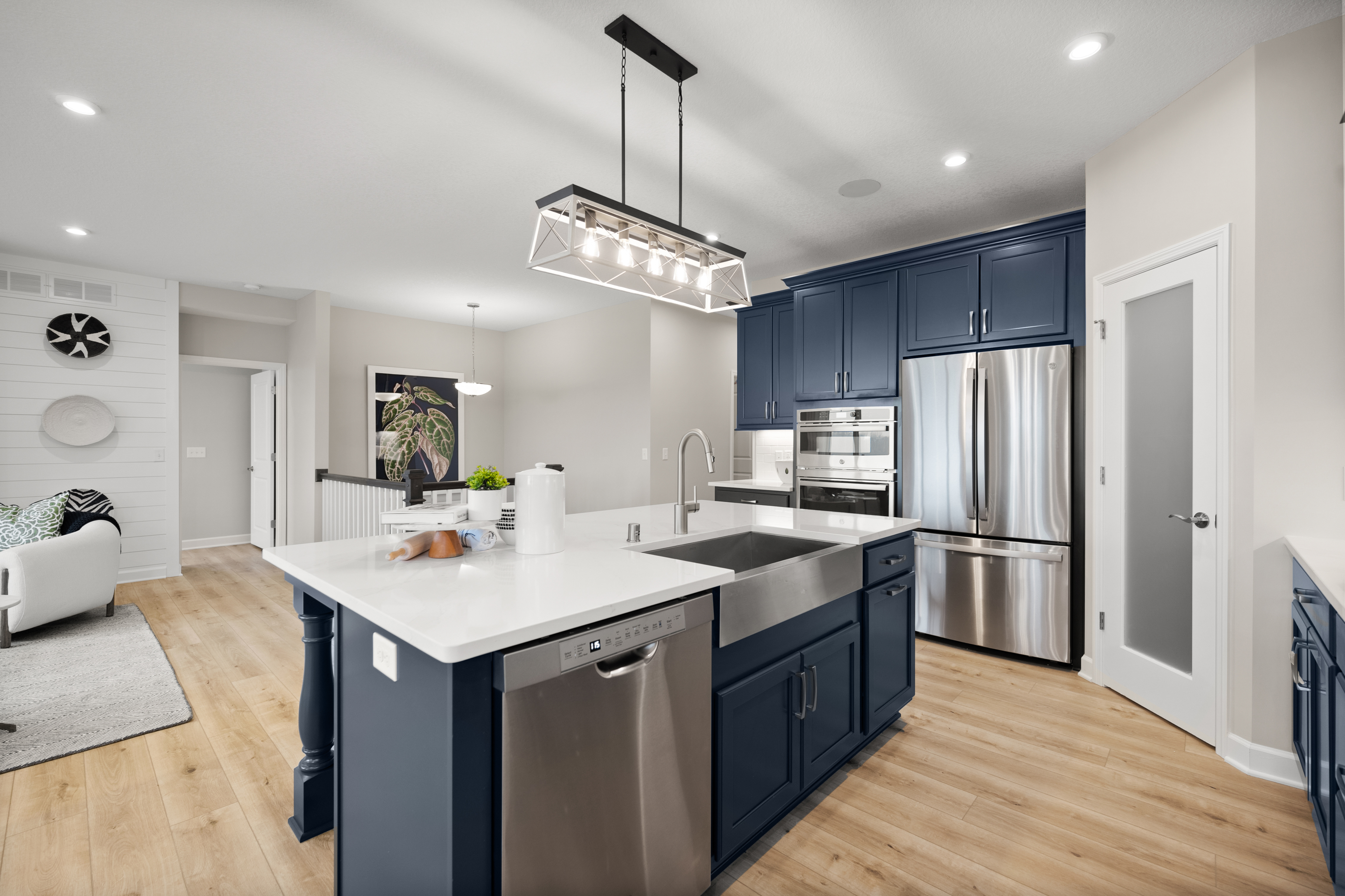 Open-Concept Kitchen With Dark Blue Cabinets