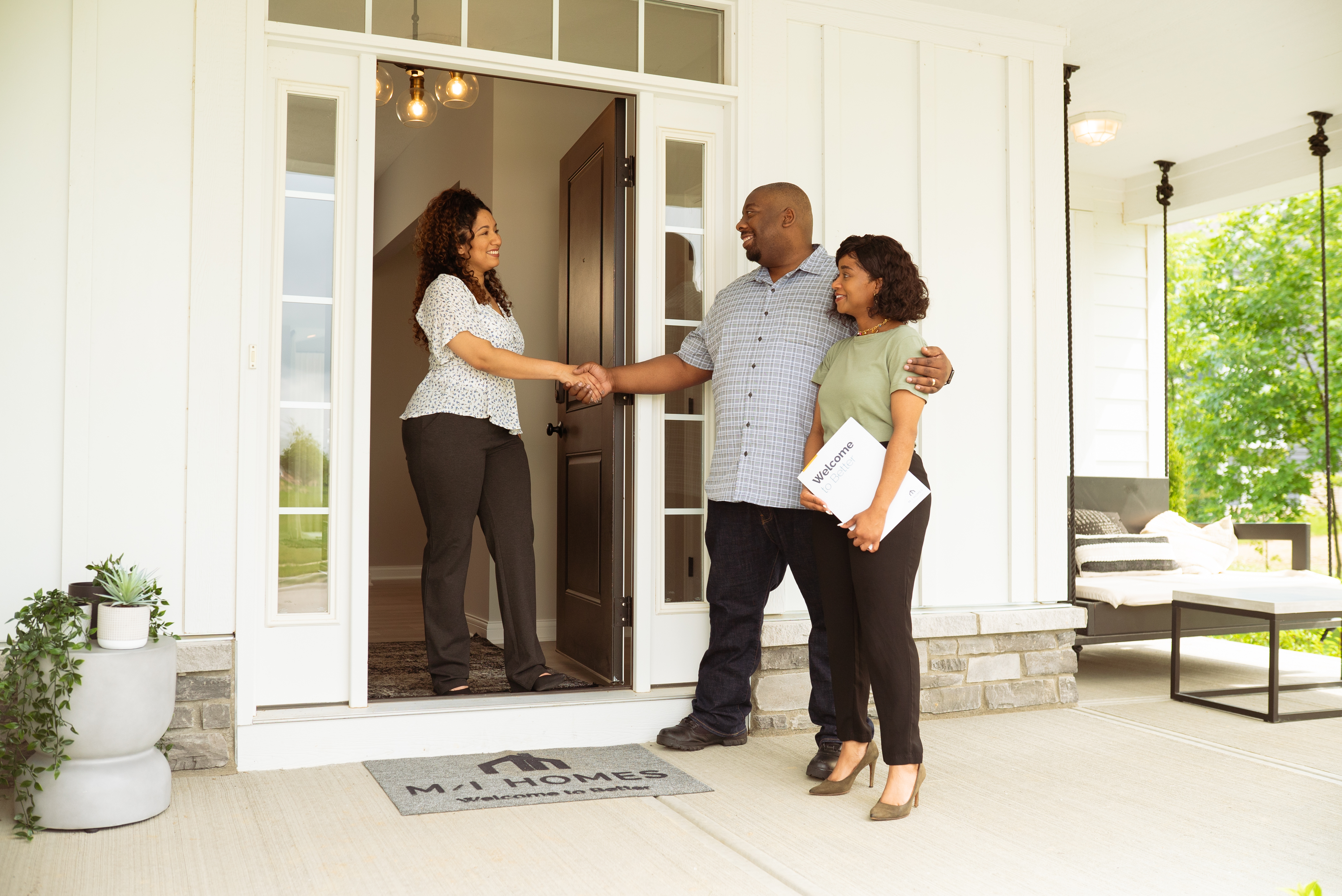 Couple Meeting With New Home Consultant at M/I Homes Model Home