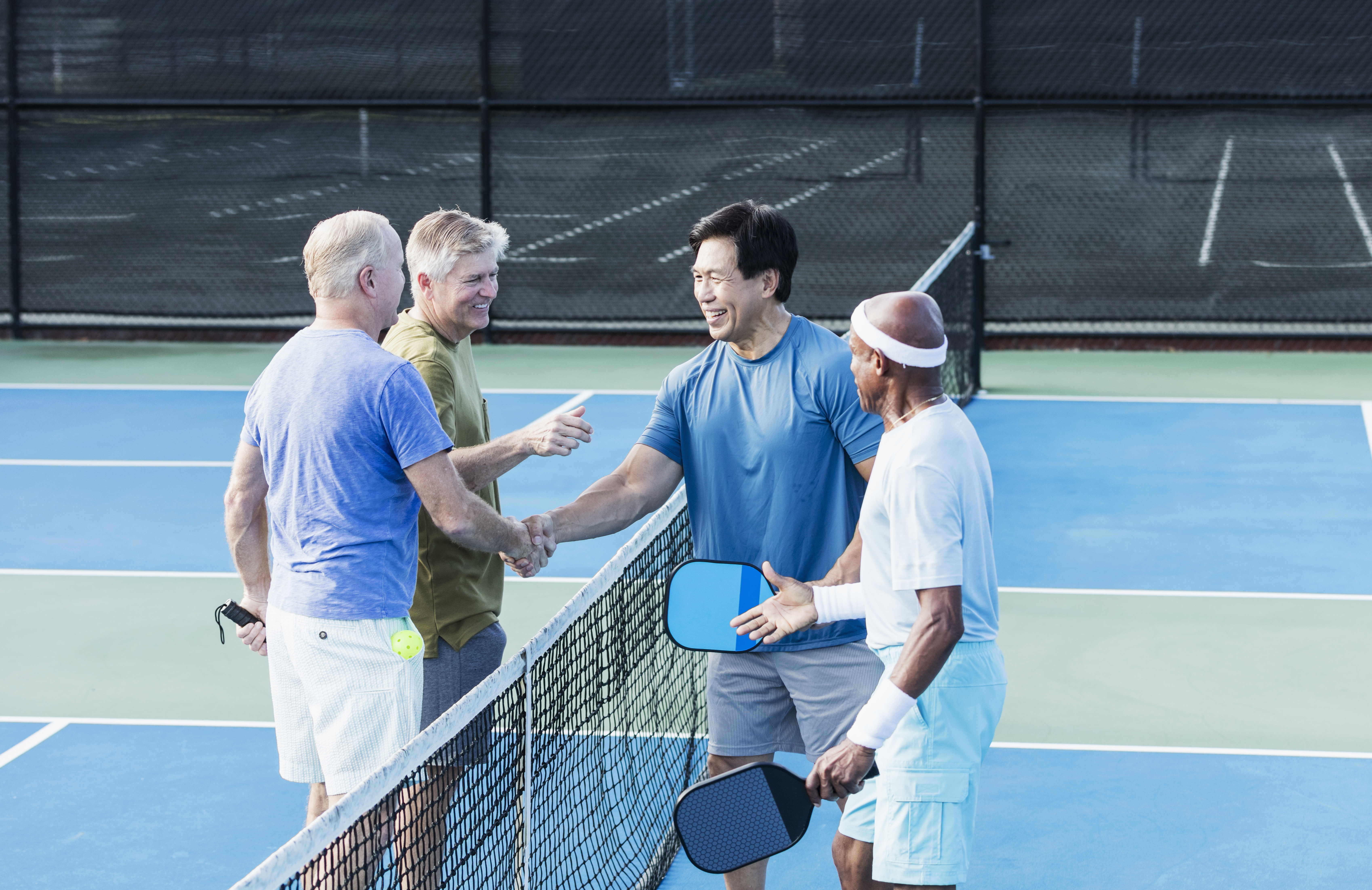 Men Shaking Hands on Tennis Court
