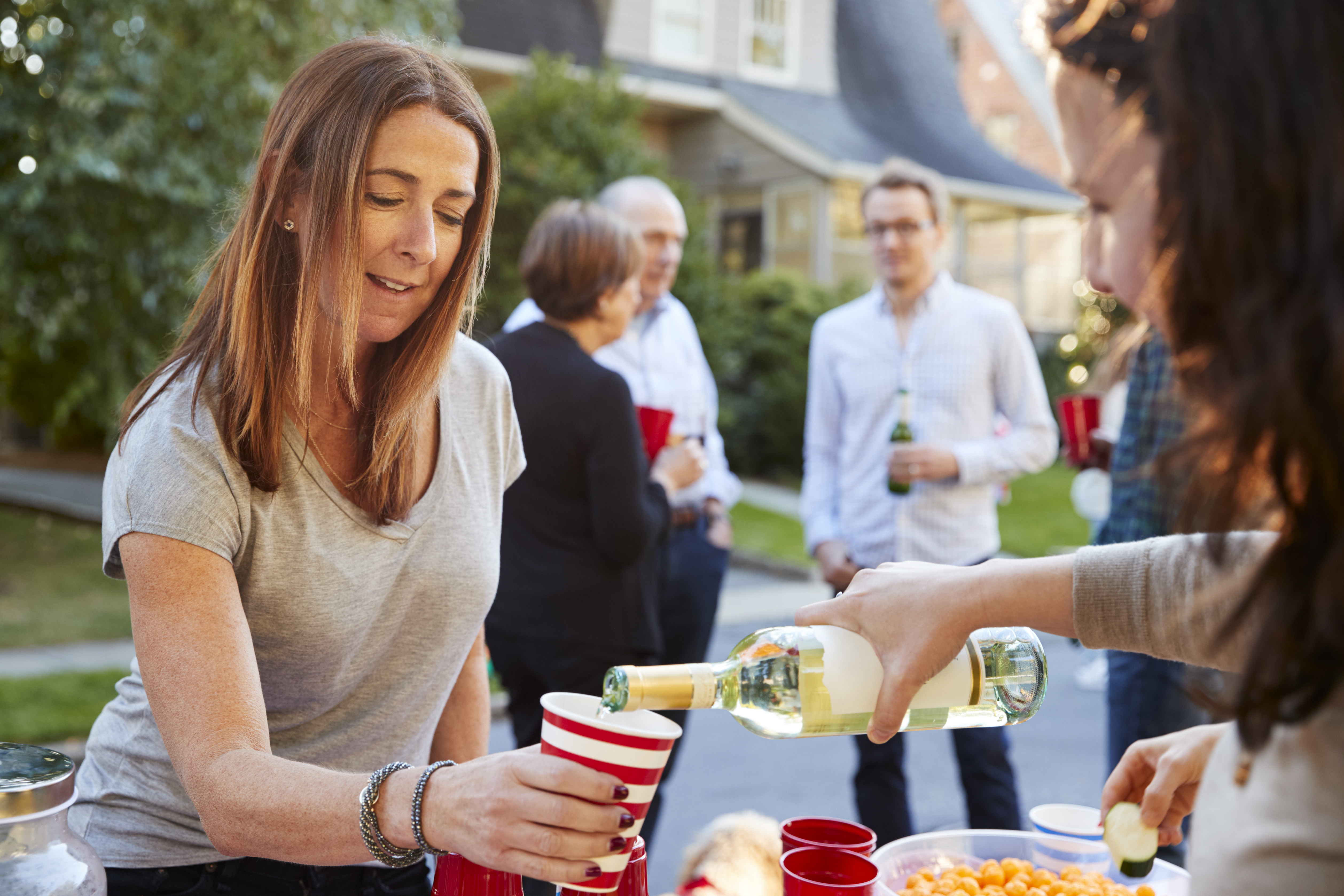 Pouring Wine Into Paper Cup