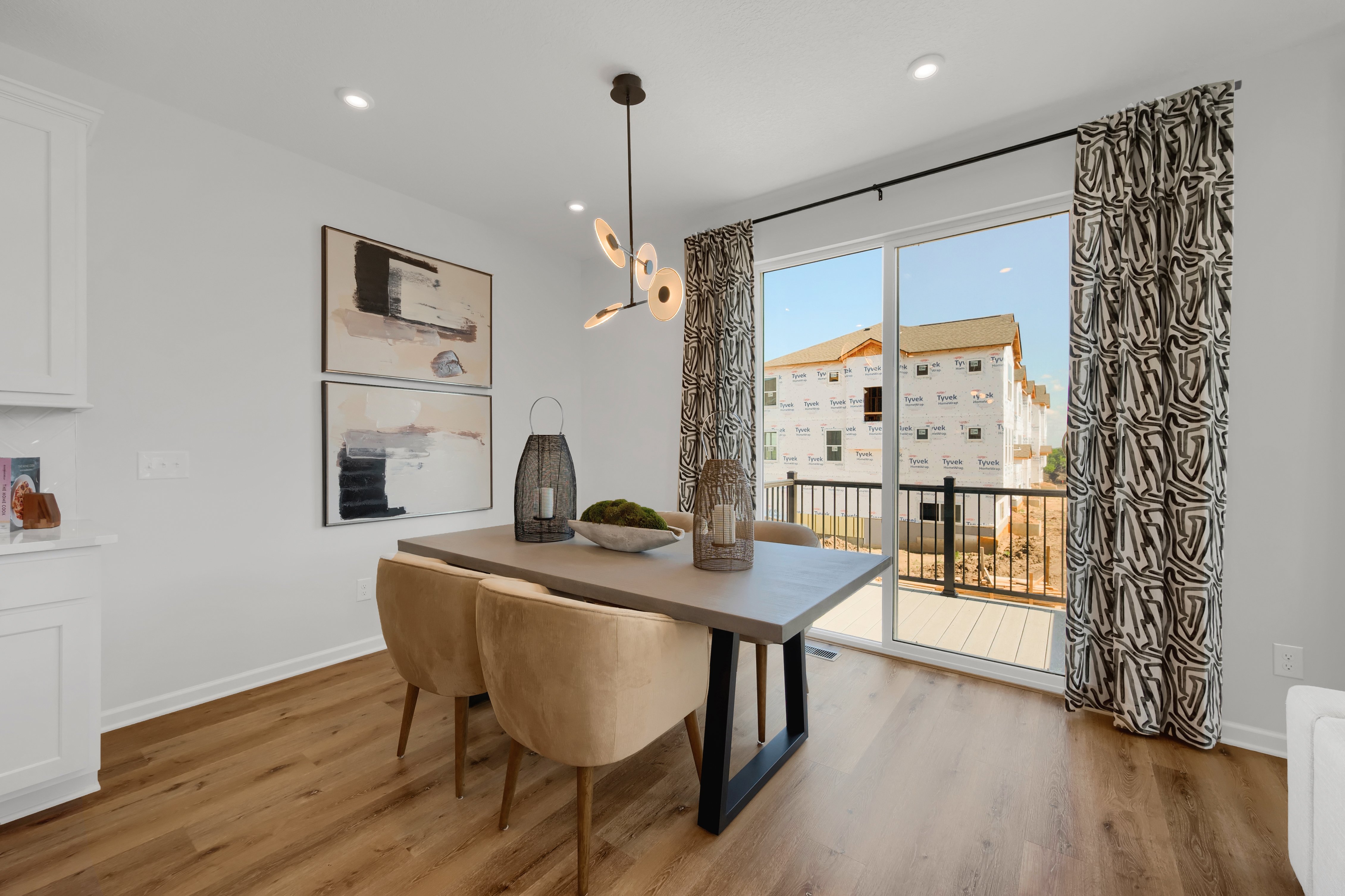 Dining Room With Wall Art at End of Table