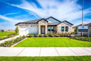 This is the front exterior of the Hawkins plan. This is the model home located in Carillon at 13305 Eppright Trace Blvd., Manor, TX