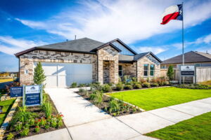This is the front exterior of the Hawkins plan. This is the model home located in Carillon at 13305 Eppright Trace Blvd., Manor, TX