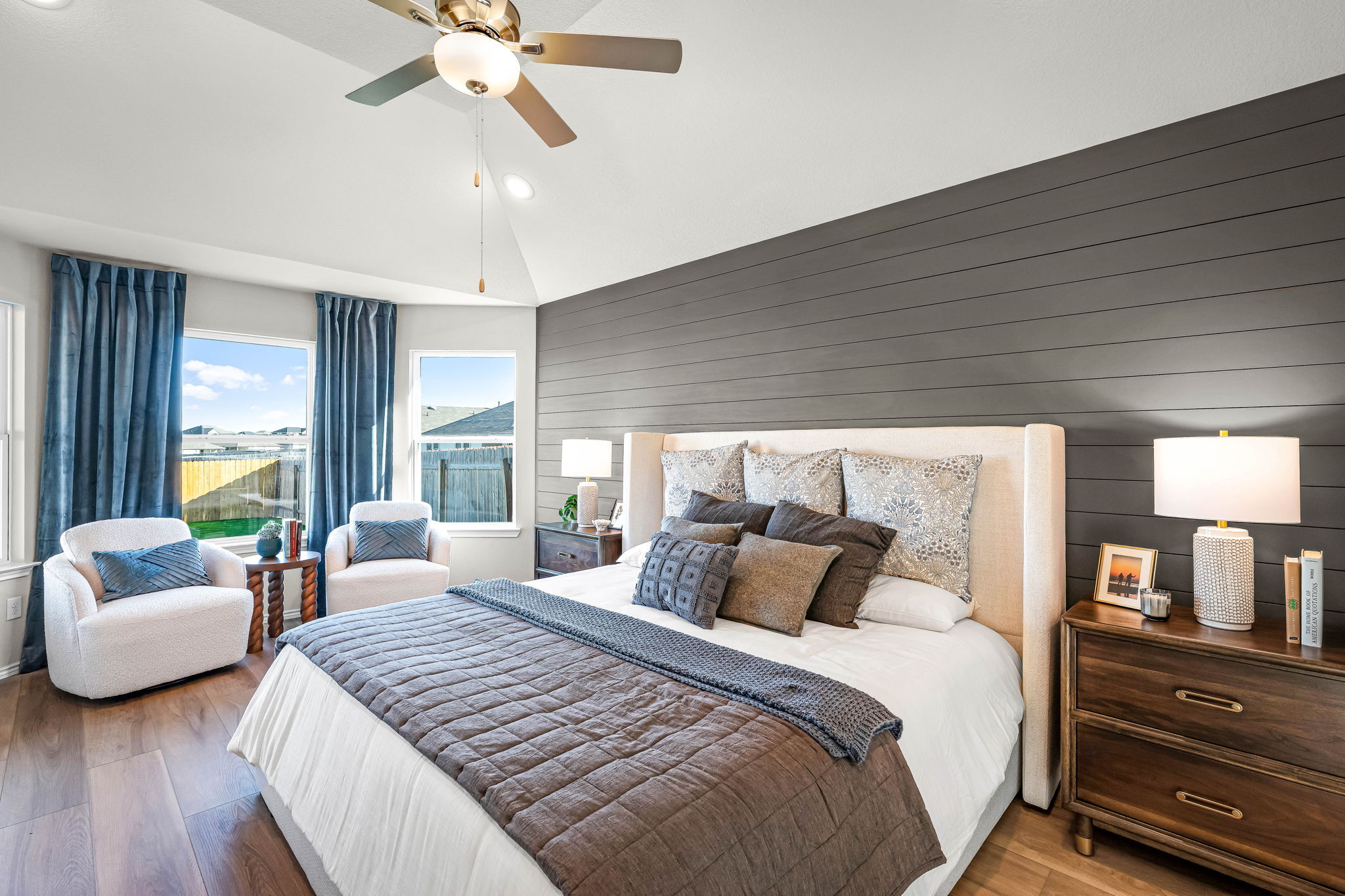 Primary bedroom in the model home located in Carillon at 13305 Eppright Trace Blvd., Manor, TX 