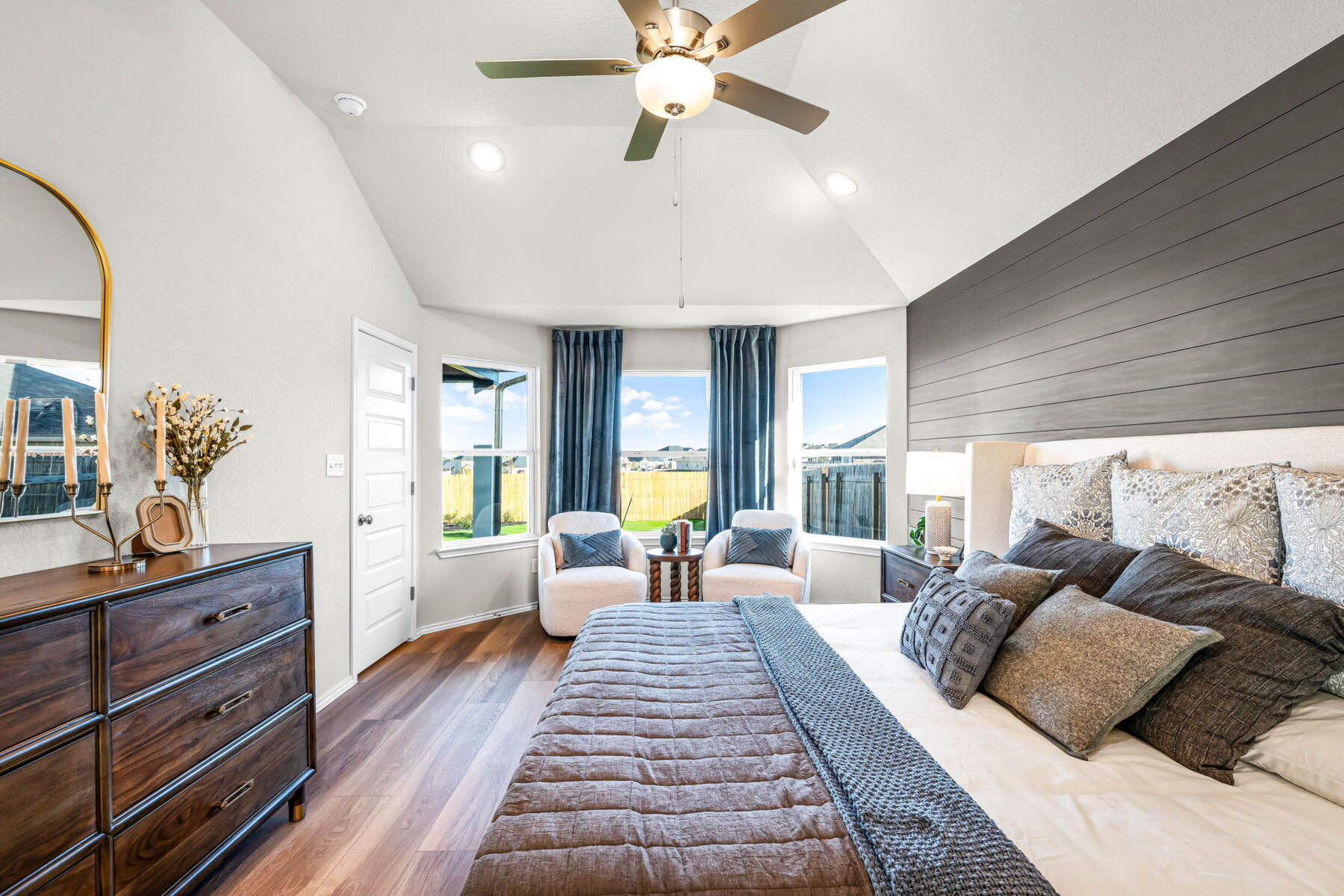 Primary bedroom in the model home located in Carillon at 13305 Eppright Trace Blvd., Manor, TX 