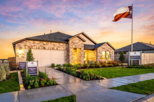 This is the front exterior of the Hawkins plan. This is the model home located in Carillon at 13305 Eppright Trace Blvd., Manor, TX