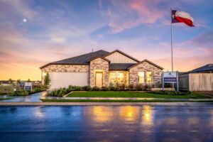 This is the front exterior of the Hawkins plan. This is the model home located in Carillon at 13305 Eppright Trace Blvd., Manor, TX