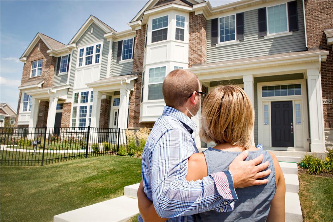 Homebuyers Standing Outside Townhome