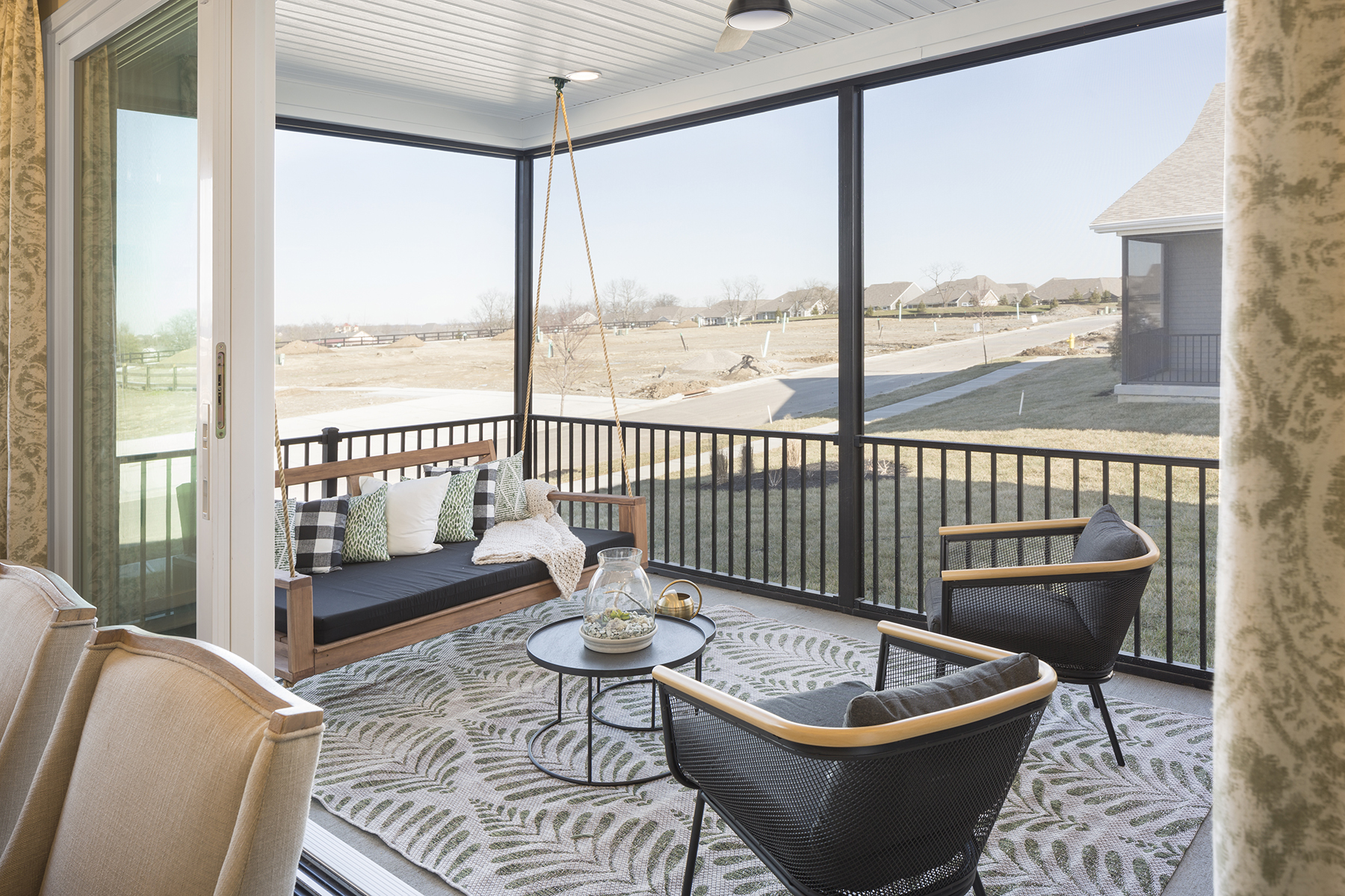 Decorated Screened-In Porch With Porch Swing