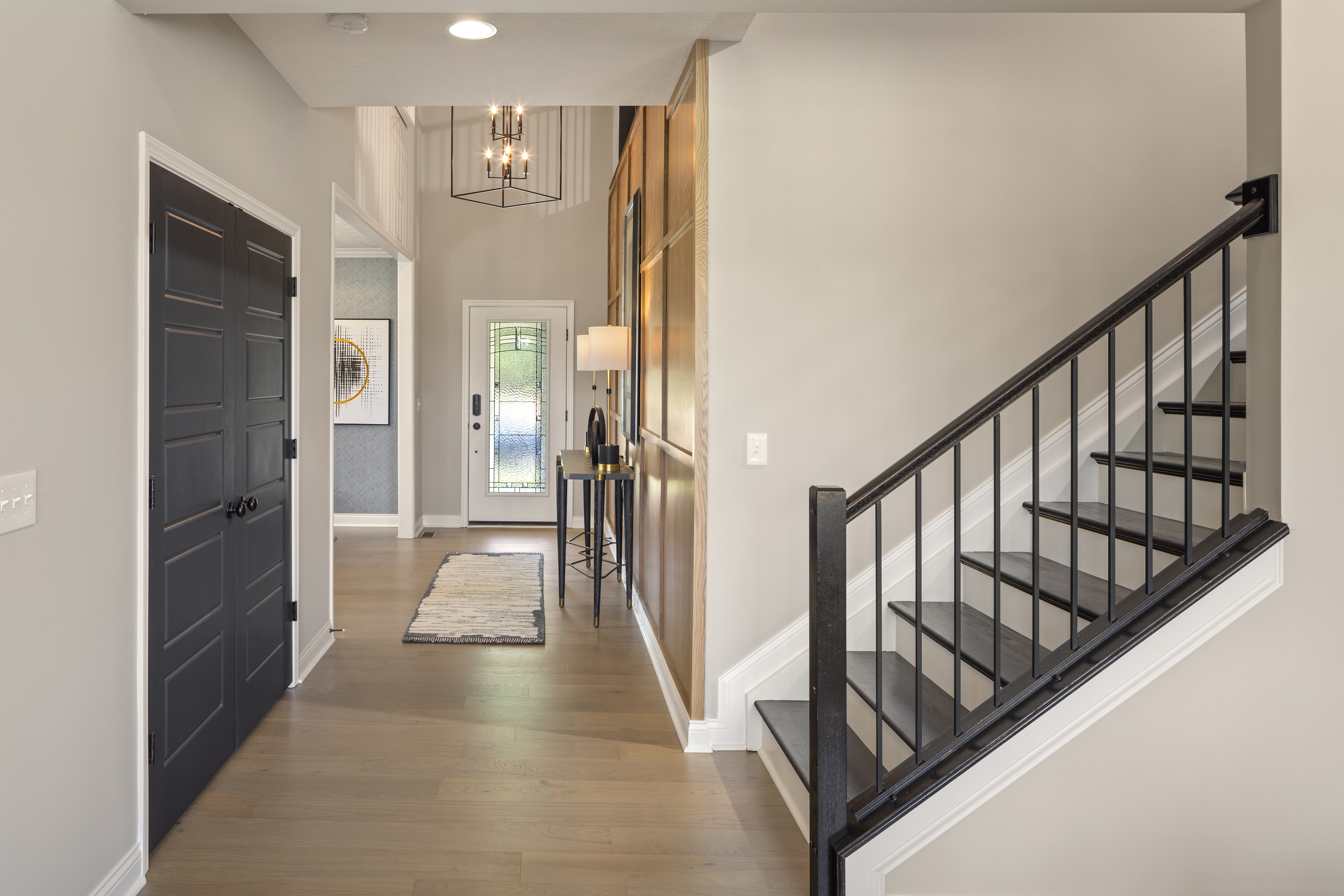 [Set of dark, vinyl stairs off a foyer in a home]