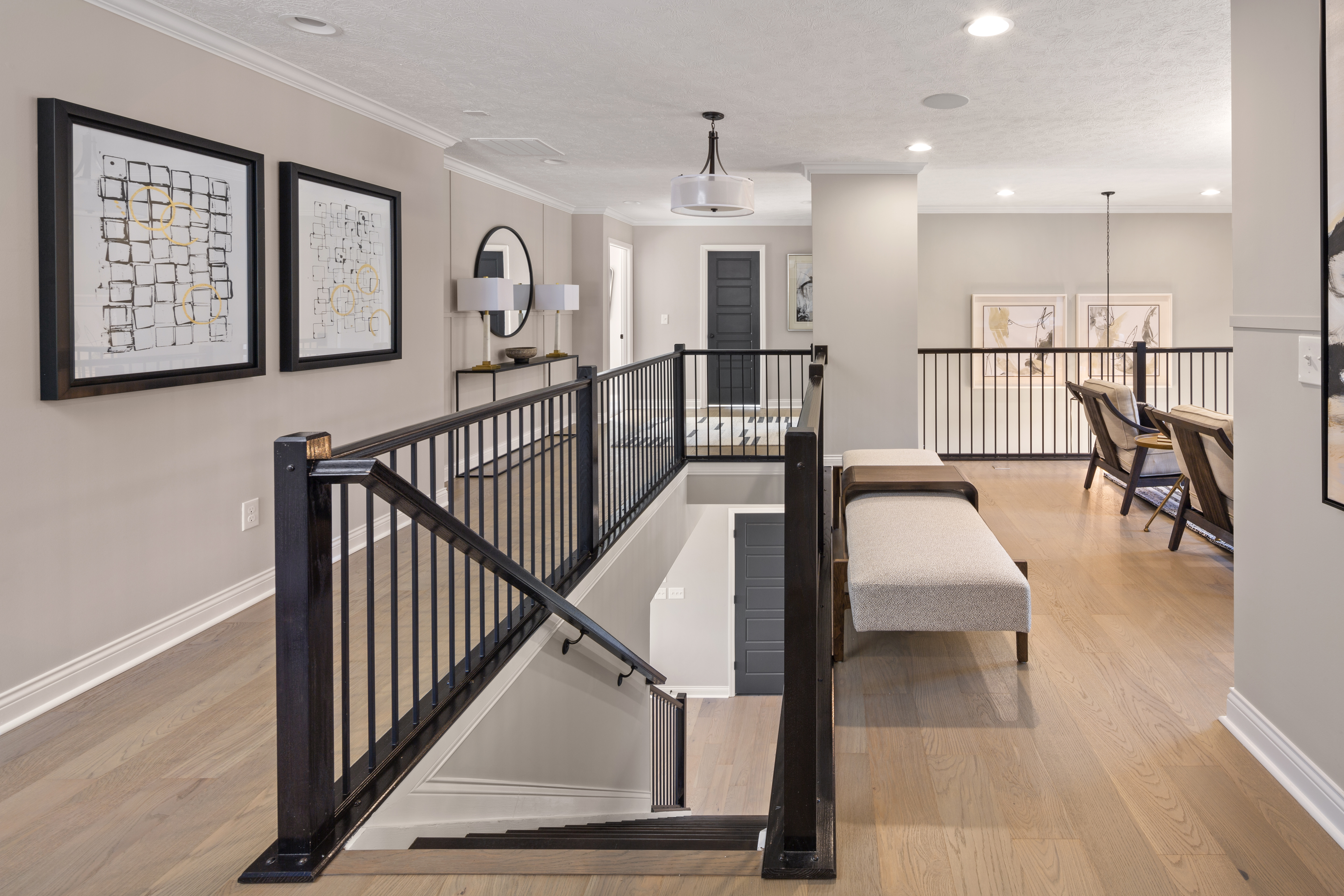 Long loft hallway with wall art and benches